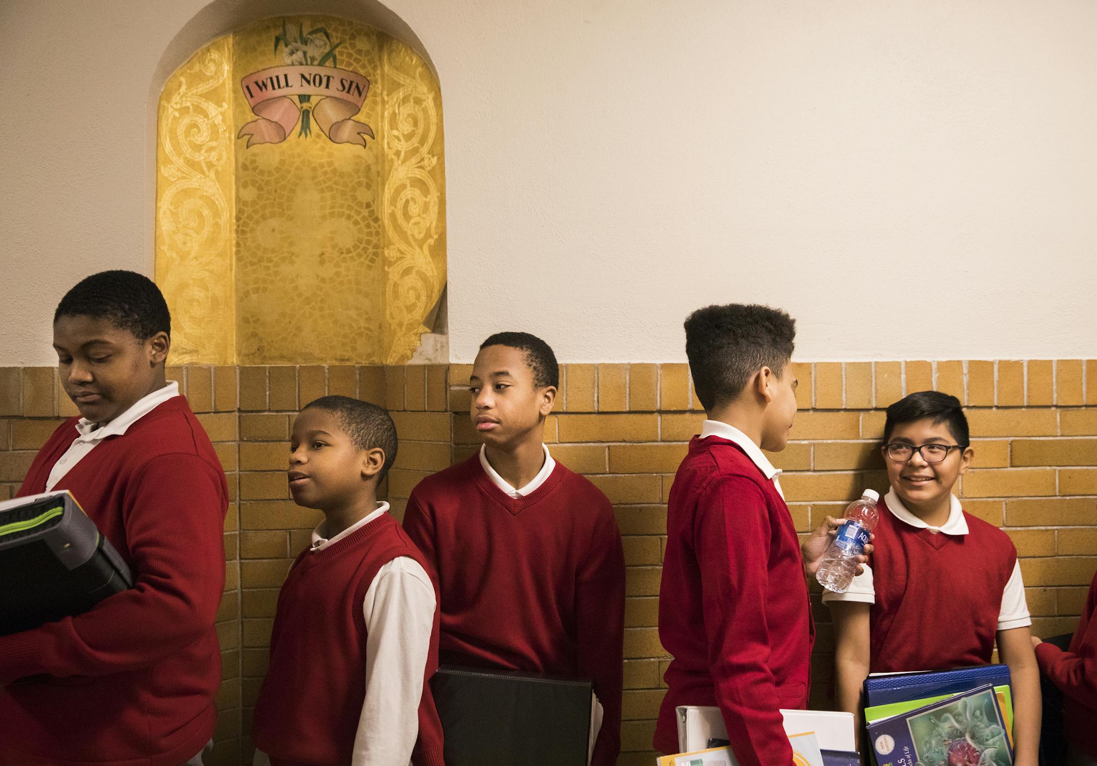 Seventh-graders at Ascension Catholic school in north Minneapolis waited in the hallway to go into class between periods. From left are James Lockhart, Raymond Moore, Malikai Bogan, Antigua Roberts, Gabriel Palmas Santiago and Brian Guaman.