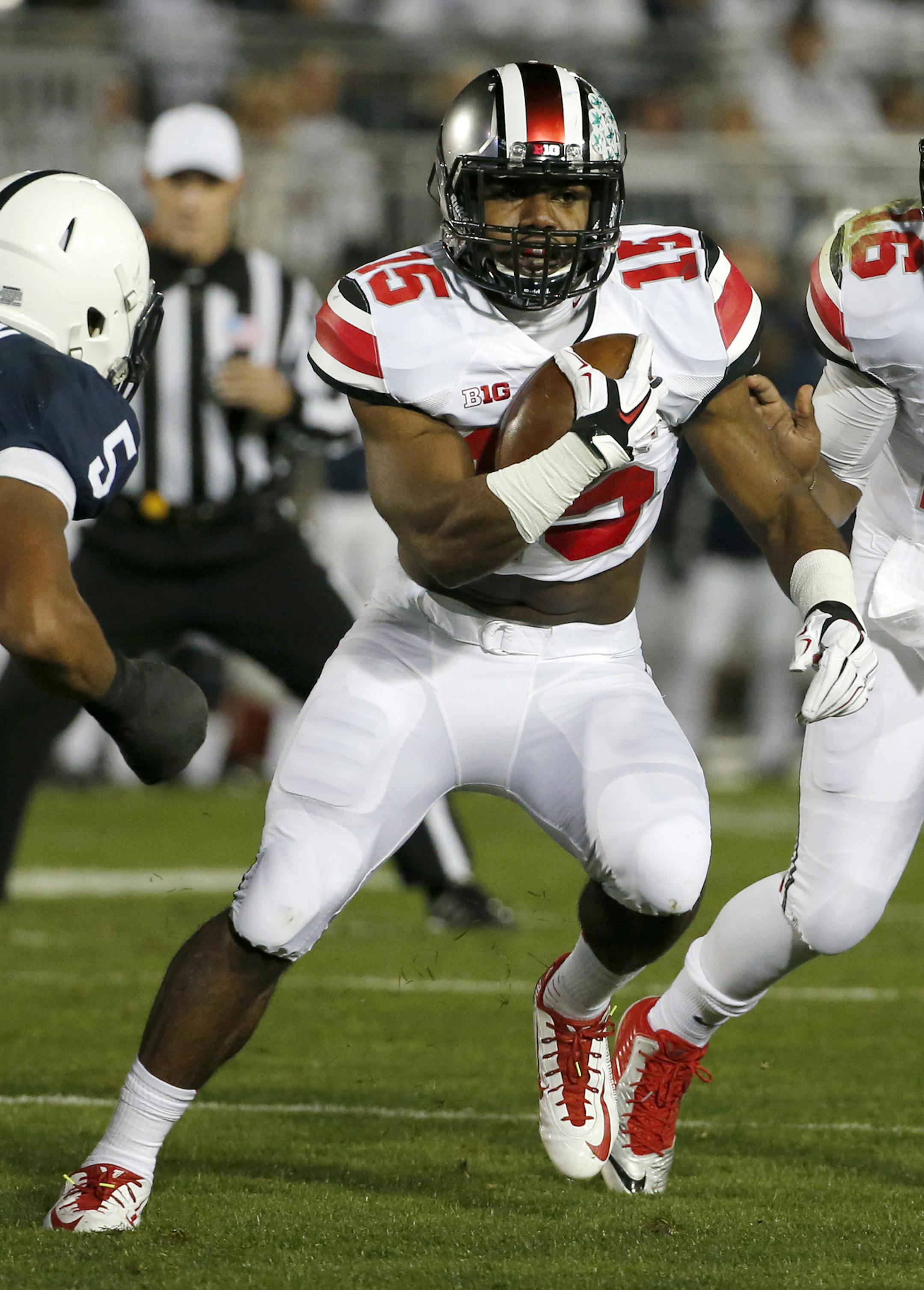 Ohio State running back Ezekiel Elliott (15) carries the ball for a touchdown during the first quarter an NCAA college football game against Penn State in State College, Pa., Saturday, Oct. 25, 2014. (AP Photo/Gene J. Puskar) ORG XMIT: PAGP107