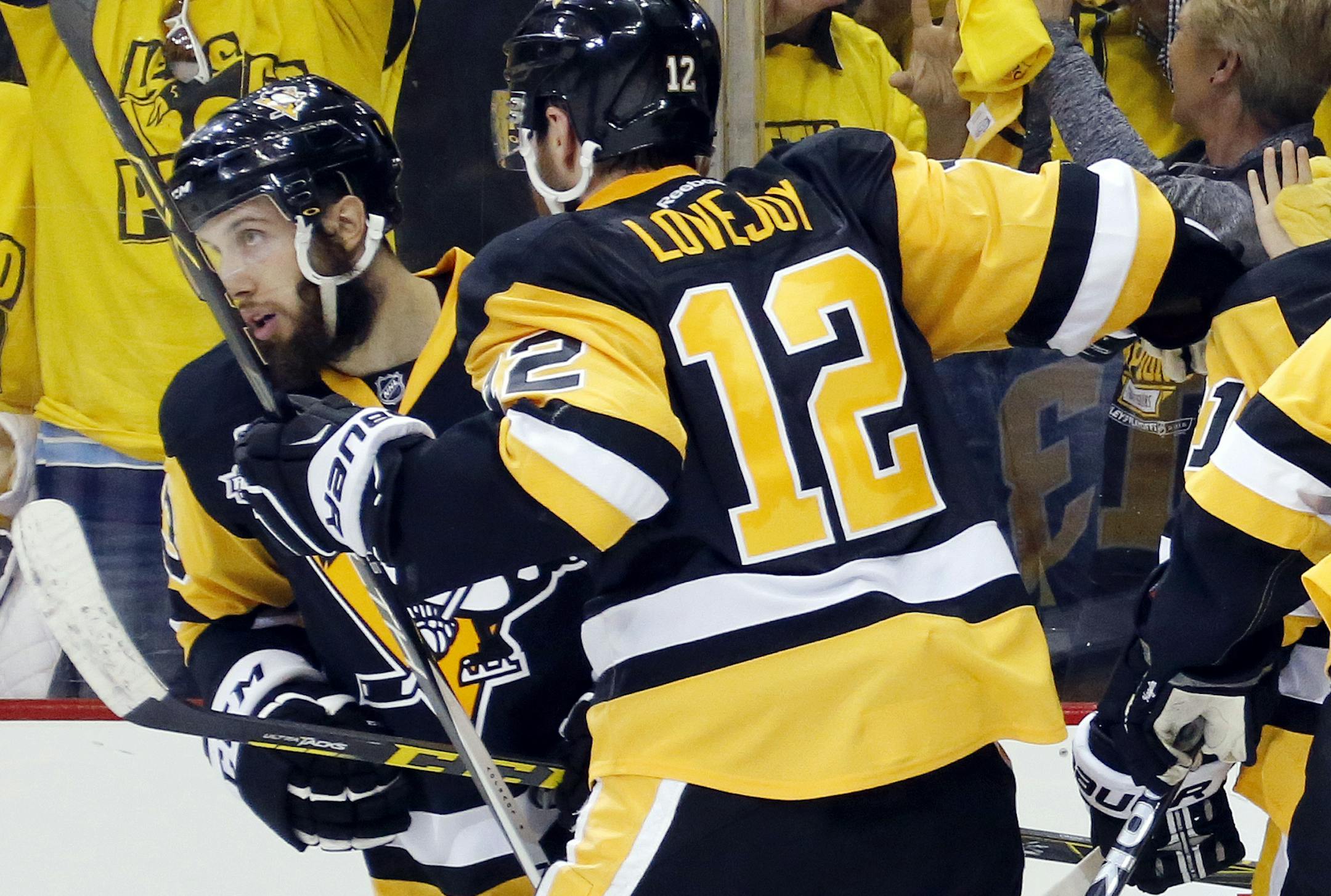 Pittsburgh Penguins' Nick Bonino, rear, celebrates his game-winning goal against the San Jose Sharks with Ben Lovejoy (12) during the third period in Game 1 of the Stanley Cup final series Monday, May 30, 2016, in Pittsburgh. (AP Photo/Keith Srakocic)