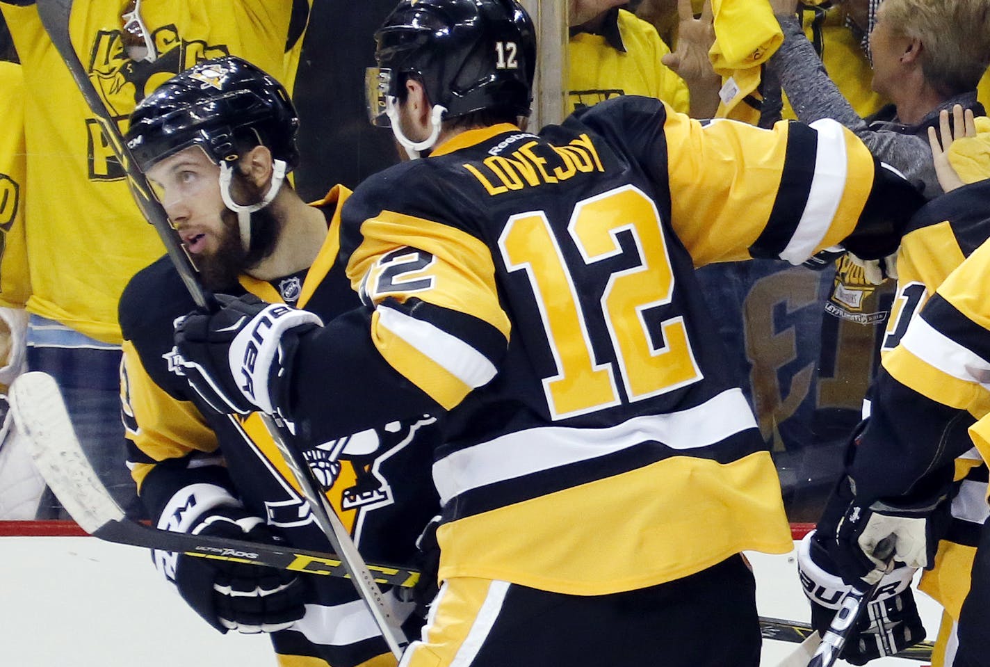 Pittsburgh Penguins' Nick Bonino, rear, celebrates his game-winning goal against the San Jose Sharks with Ben Lovejoy (12) during the third period in Game 1 of the Stanley Cup final series Monday, May 30, 2016, in Pittsburgh. (AP Photo/Keith Srakocic)