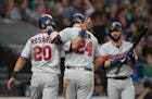 Minnesota Twins' Eddie Rosario, left, and C.J. Cron celebrate after Cron hit a two-run home run off of Seattle Mariners starting pitcher Erik Swanson 