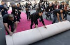 Crew members are trailed by media as they roll out the red carpet for Sunday's 90th Academy Awards in front of the Dolby Theatre on Wednesday, Feb. 28