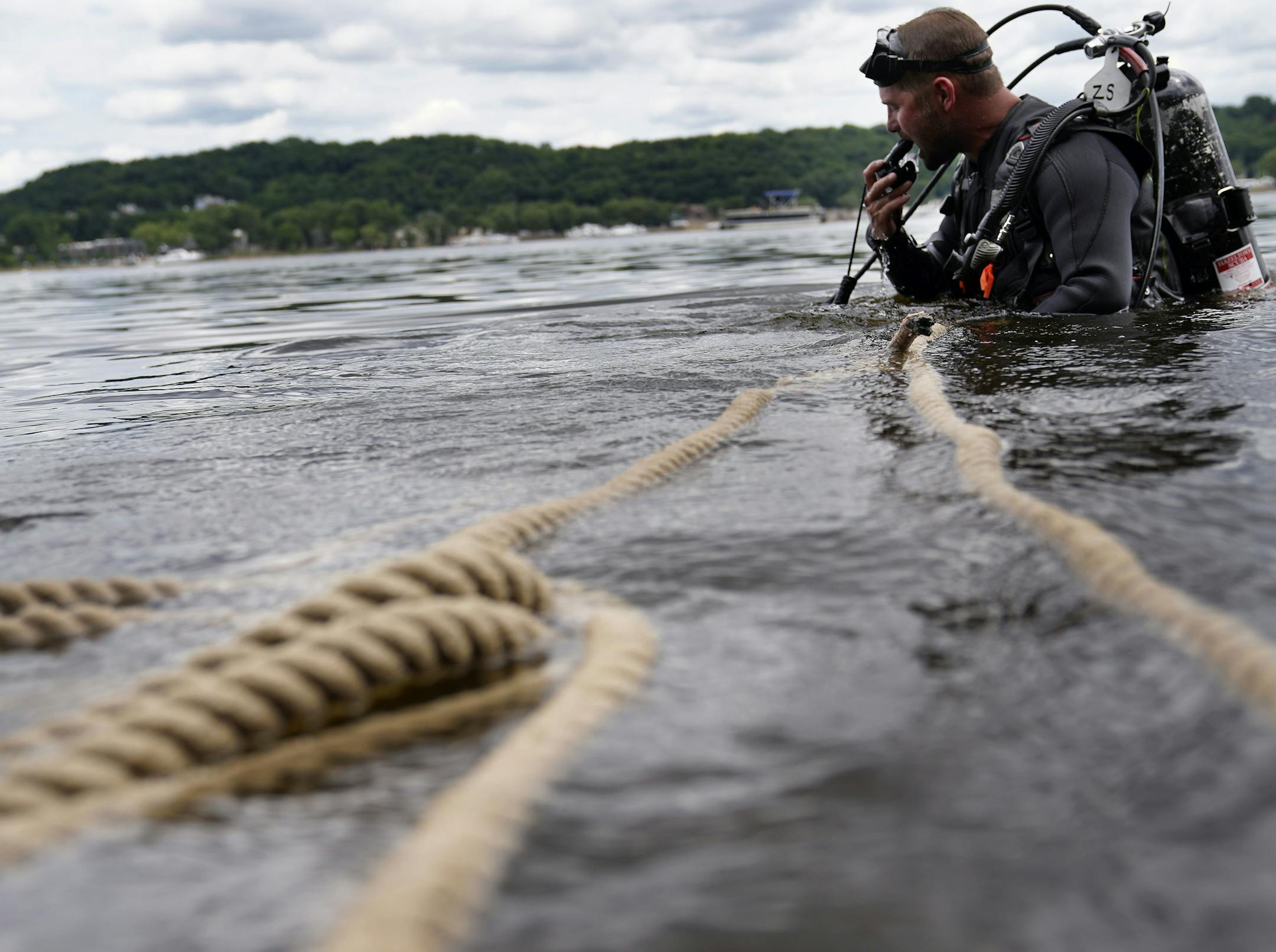 A Minnesota DNR crew transplanted 3,506 mussels native to Minnesota -- including Higgins' eye, bucket and snuffbox-- to grow in the waters of the St. Croix River, across from Hudson, WI, Tuesday in Lakeland, MN. Here, Minnesota Department of Natural Resources crew member Zeb Secrist, Minnesota DNR natural resources specialist, searches the river for mussels that were transplanted last year in the St. Croix.] DAVID JOLES • david.joles@startribune.com For the first time in a century the state is g