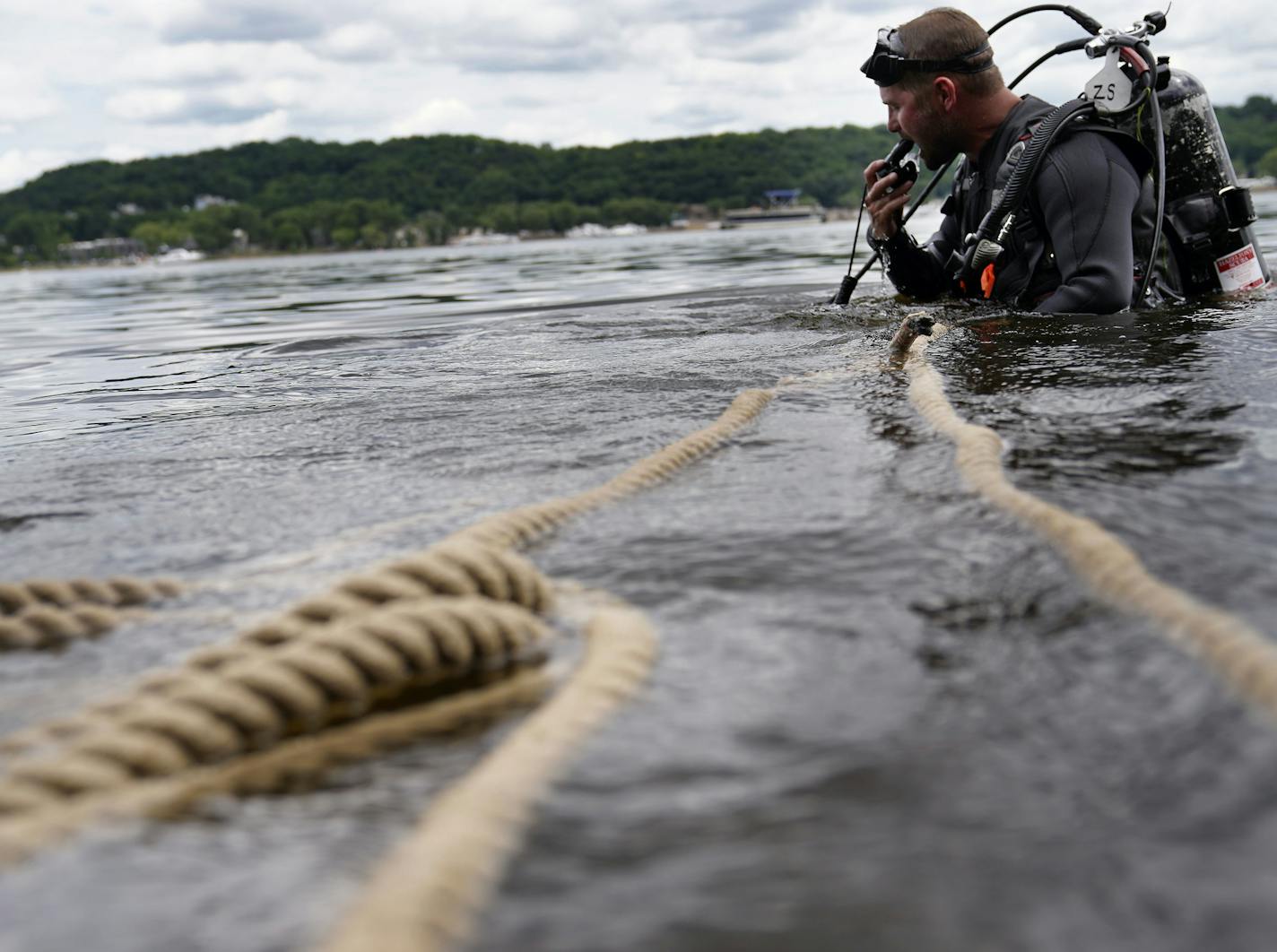 A Minnesota DNR crew transplanted 3,506 mussels native to Minnesota -- including Higgins' eye, bucket and snuffbox-- to grow in the waters of the St. Croix River, across from Hudson, WI, Tuesday in Lakeland, MN. Here, Minnesota Department of Natural Resources crew member Zeb Secrist, Minnesota DNR natural resources specialist, searches the river for mussels that were transplanted last year in the St. Croix.] DAVID JOLES • david.joles@startribune.com For the first time in a century the state is g