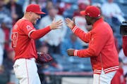 Mike Trout, left, high-fives Angels special assistant Torii Hunter after Hunter threw the ceremonial first pitch against the Boston Red Sox on April 6