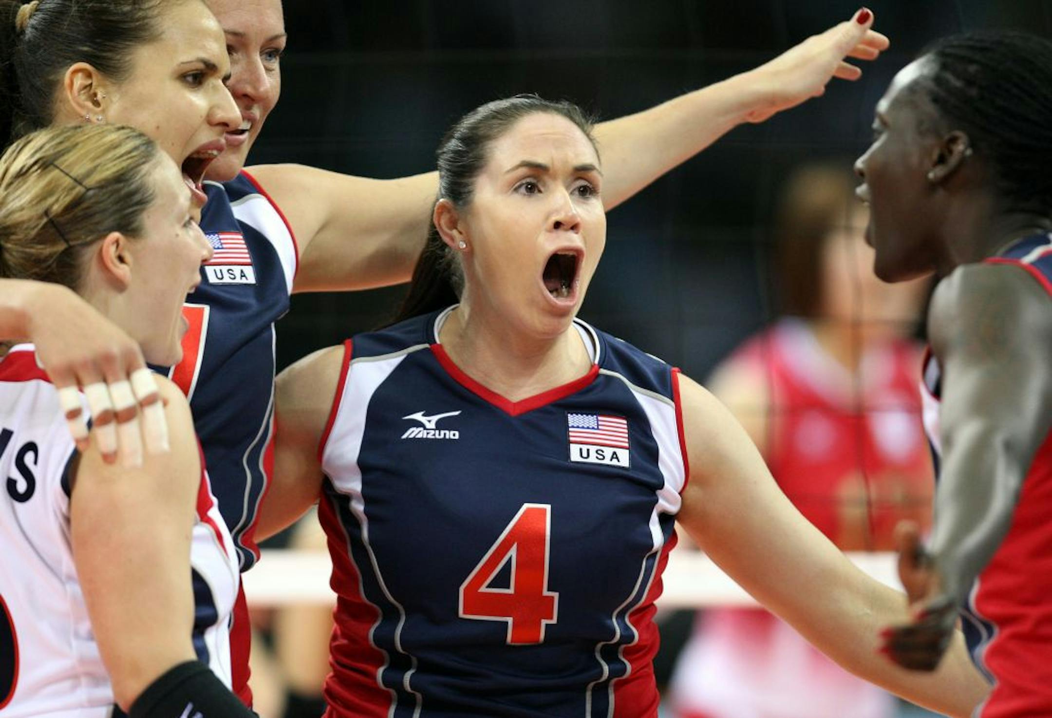 USA�s Lindsey Berg (4) celebrated with teammates after a point. USA beat Japan in four sets. Berg is a former University of Minnesota standout player.