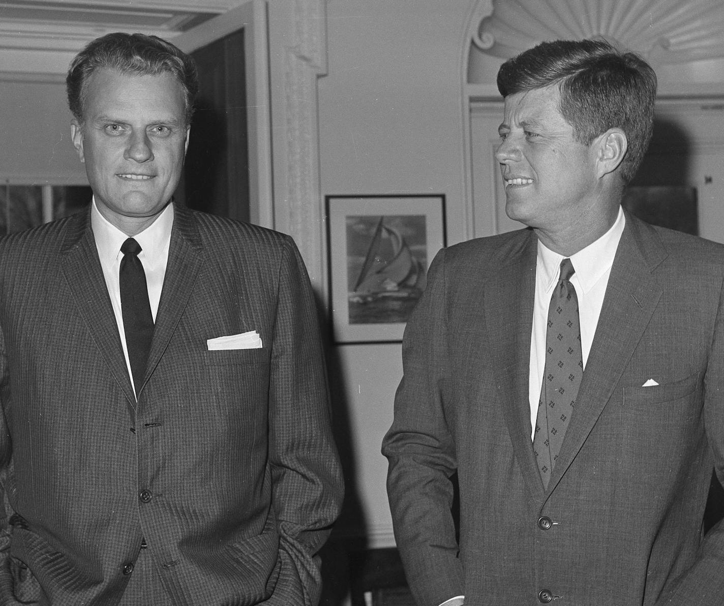 FILE - In this Dec. 12, 1961 file photo, Evangelist Billy Graham, left, talks with President John F. Kennedy during a call at the the White House in Washington. Graham, who transformed American religious life through his preaching and activism, becoming a counselor to presidents and the most widely heard Christian evangelist in history, has died. Spokesman Mark DeMoss says Graham, who long suffered from cancer, pneumonia and other ailments, died at his home in North Carolina on Wednesday, Feb. 2