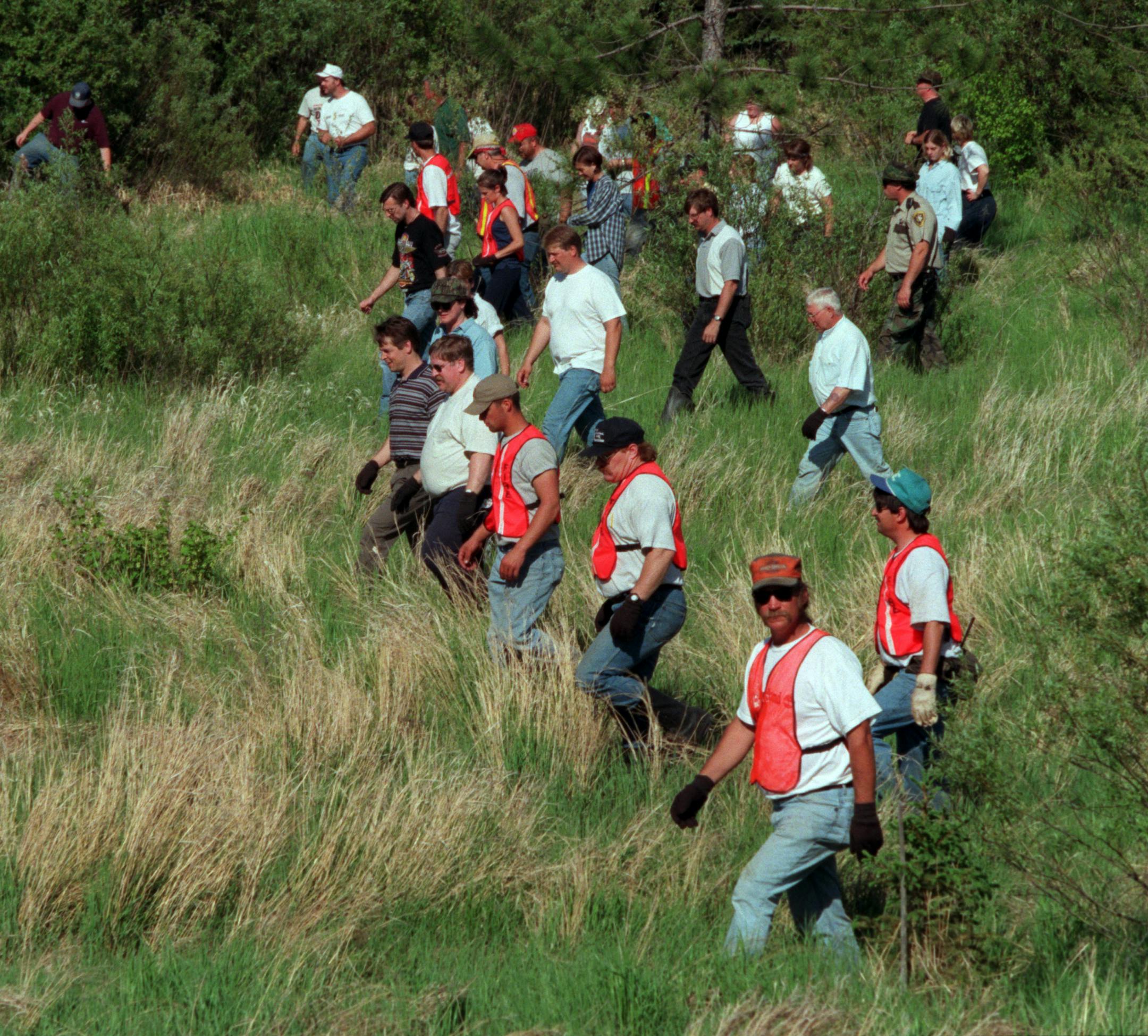 Law enforcement officers and civilian volunteers scoured the wooded countryside near the Moose Lake store where Katie Poirier was abducted.