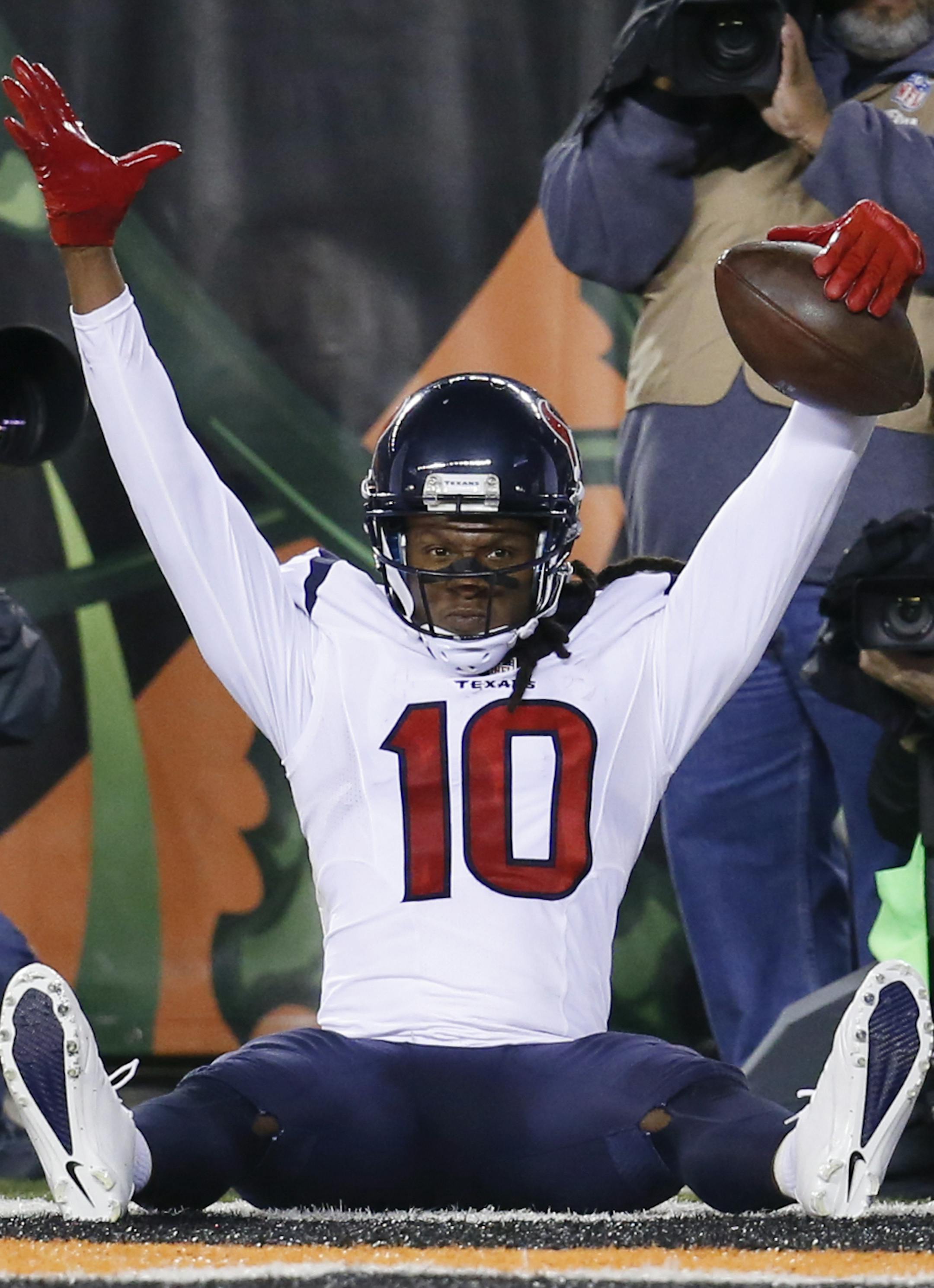 Houston Texans wide receiver DeAndre Hopkins (10) celebrates after scoring a touchdown as Cincinnati Bengals strong safety George Iloka (43) stands to the side in the second half of an NFL football game in Cincinnati, Monday, Nov. 16, 2015. (AP Photo/Frank Victores)