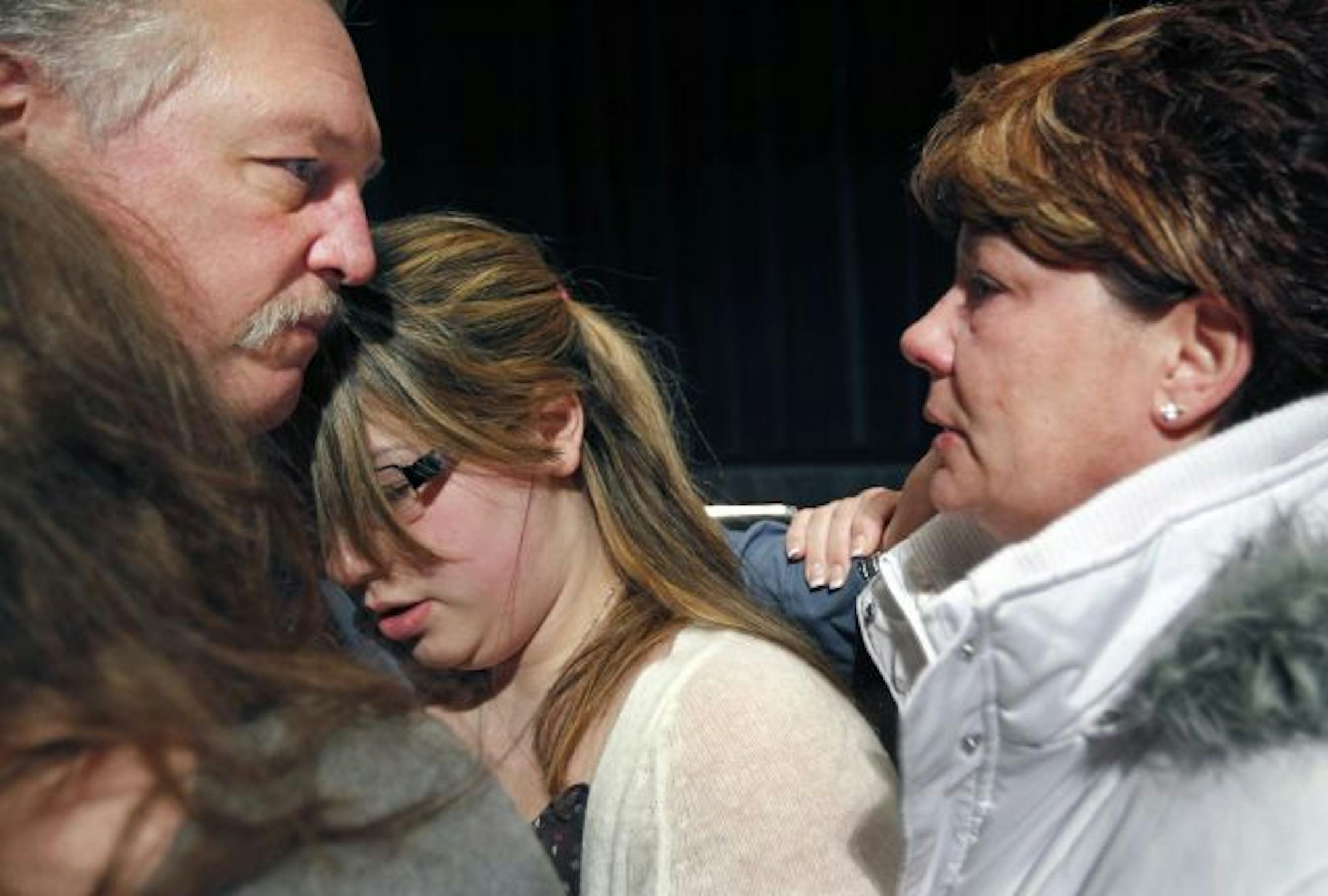 After the ceremony, Saint Paul Police Officer Dave Longbehn hugged Allie, Sam, and Gail Bergeron, the daughters and wife of slain Maplewood Sgt. Joseph Bergeron.