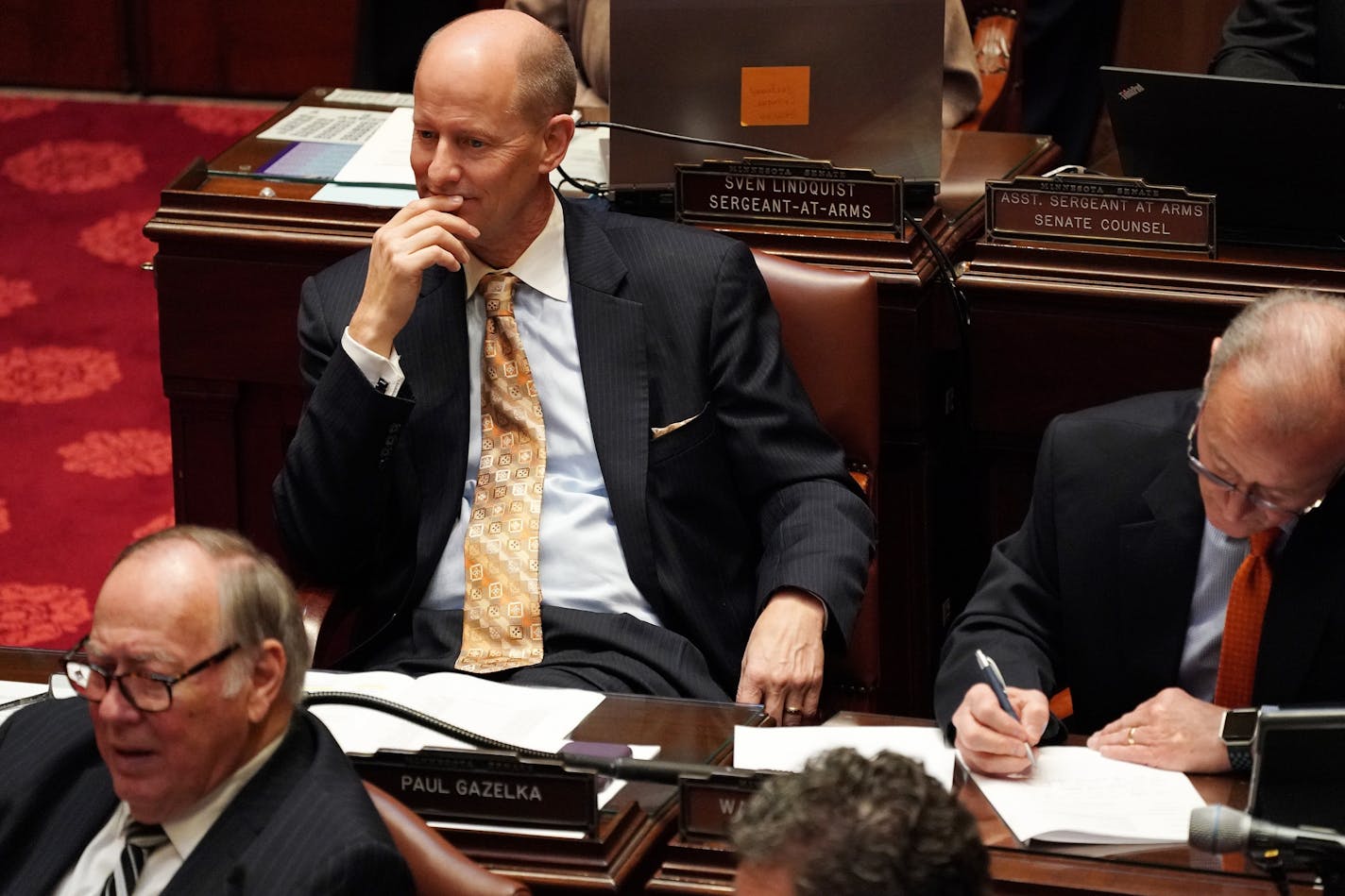 Senate republican majority leader Sen. Paul Gazelka (R-Nisswa) watched as incoming Senate President Sen. Jeremy Miller (R-Winona) took the oath of office in the Senate Chamber on the first day of the legislative session.