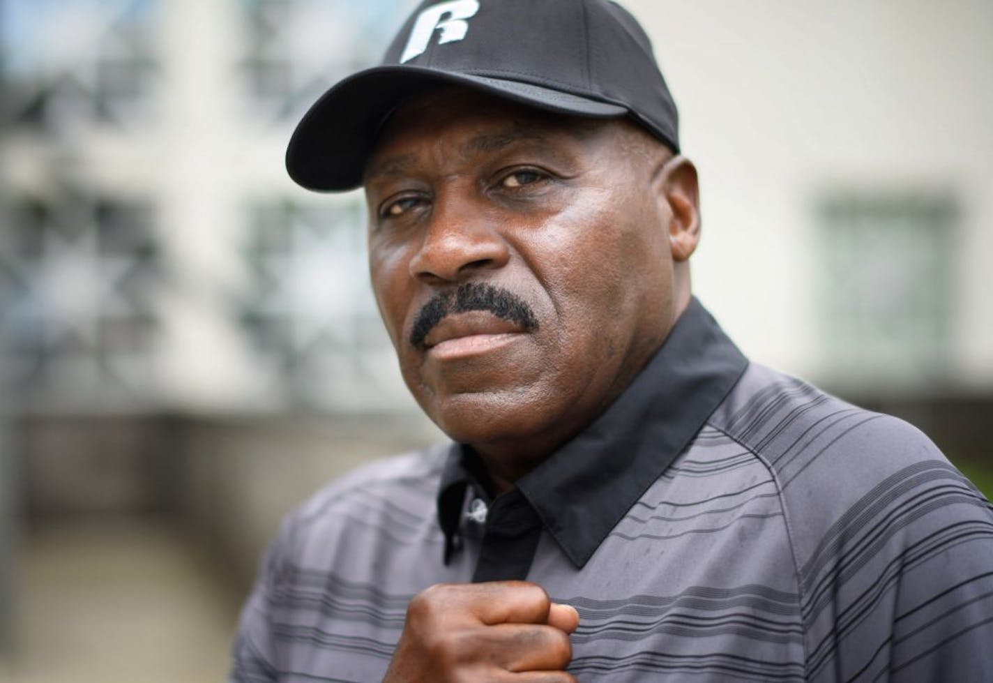 Activist who helped found The Way, Spike Moss. They were photographed in front of the 4th Minneapolis police precinct, where The Way once stood.