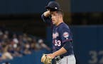 Minnesota Twins relief pitcher Pat Light reacts during sixth-inning baseball game action against the Toronto Blue Jays in Toronto, Friday, Aug. 26, 20
