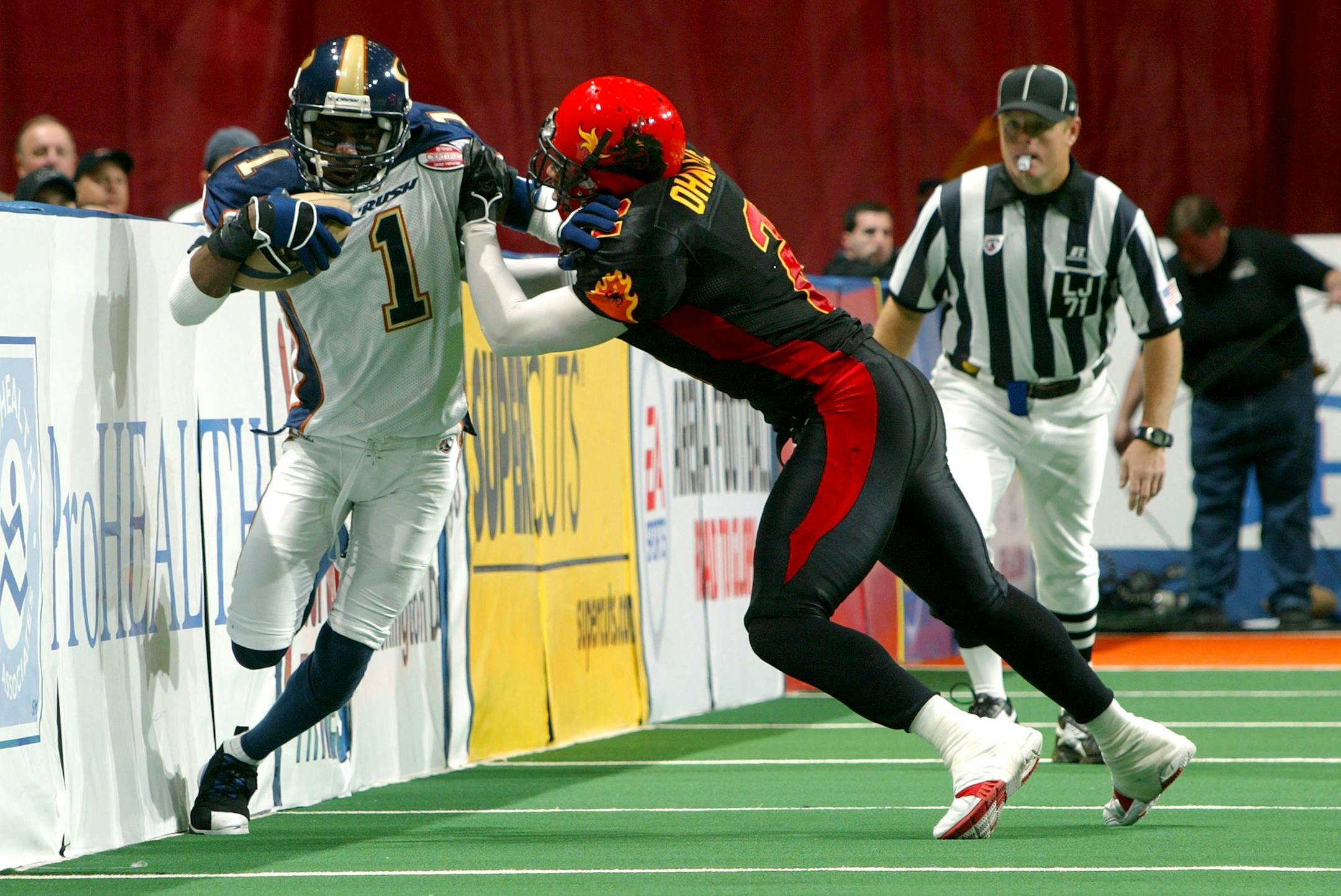 UNIONDALE, NY - APRIL 15: Damian Harrell #1 of the Colorado Crush runs by Ifeanyi Ohalete #2 of the New York Dragons on April 15, 2007 at the Nassau Coliseum in Uniondale, New York.