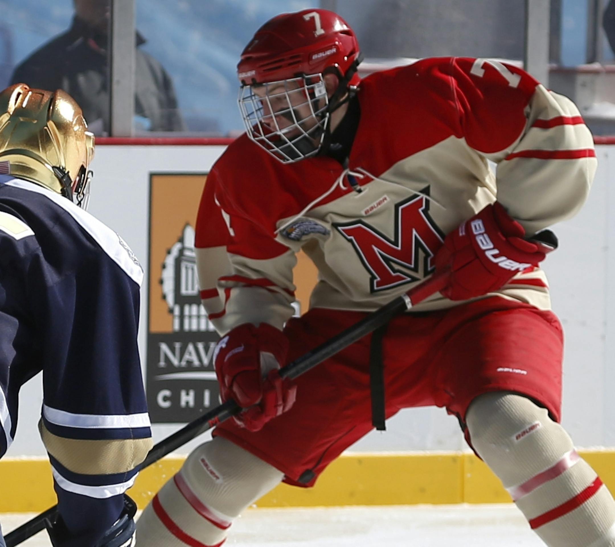 Notre Dame defenseman Kevin Lund, left, drops to the ice to blocks the shot by Miami (Ohio) forward Austin Czarnik during the first period of a college hockey game at Soldier Field, Sunday, Feb. 17, 2013, in Chicago. (AP Photo/Charlie Arbogast) ORG XMIT: ILCA103