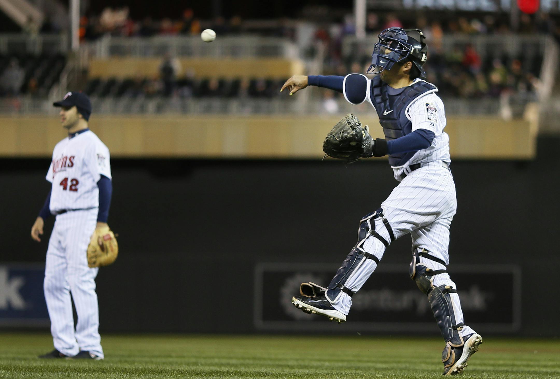 Kurt Suzuki over throws Trevor Plouffe at third base in the sixth inning allowing Toronto's Dioner Navarro to score during MLB action at Target Field between the Minnesota Twins and Toronto Blue Jays April 15, 2014 in Minneapolis , MN. ]JERRY HOLT jerry.holt@startribune.com