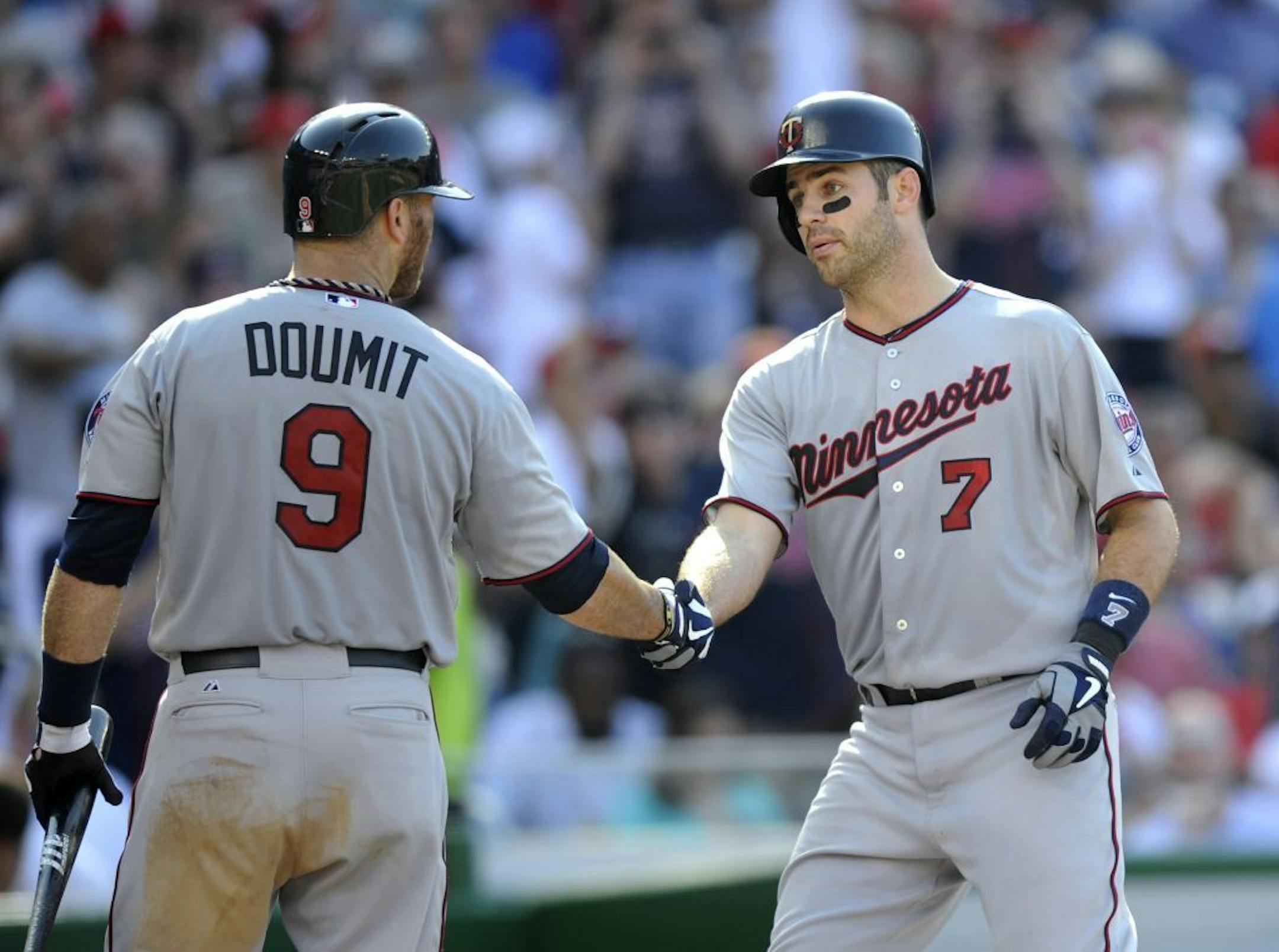 Joe Mauer celebrates his 100th career home run with Ryan Doumit during the fifth inning of an interleague game against the Washington Nationals June 8, 2013, in Washington.