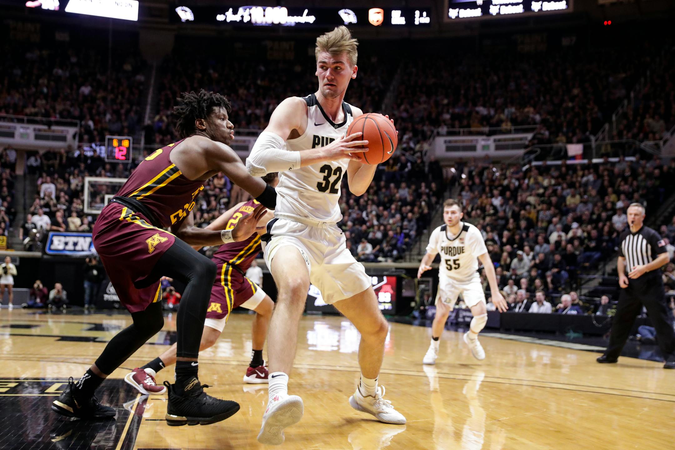 Purdue center Matt Haarms (32) drives on Minnesota center Daniel Oturu (25) during the second half of an NCAA college basketball game in West Lafayette, Ind., Thursday, Jan. 2, 2020. Purdue defeated Minnesota 83-78 in double overtime. (AP Photo/Michael Conroy)