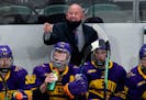 Minnesota State head coach Mike Hastings, back, directs his team against Minnesota in the second period of an NCAA College Hockey Regional Final, Sund