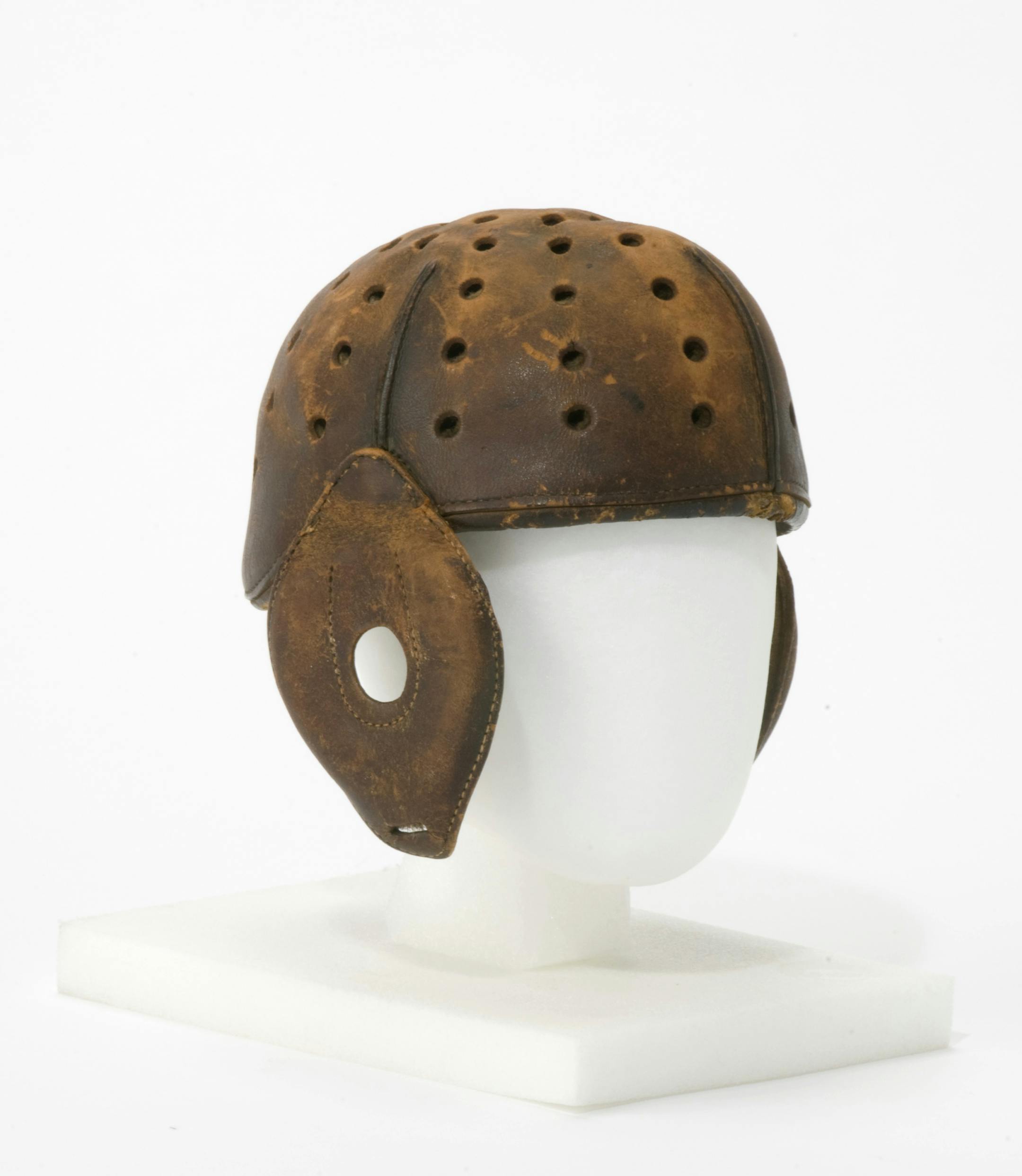 Knute Rockneís Massillon Tigers Helmet ñ During pro footballís pre-NFL years, it was not too uncommon for players to jump from team to team, often under an assumed name to hide their identity. One such player was a young Notre Dame assistant coach, Knute Rockne, who was a relatively well-known ringer with the 1919 Massillon (OH) Tigers. Apparently Massillon wasnít the only team for which he played. A former member of the Columbus Panhandles once claimed the Rockne played agai