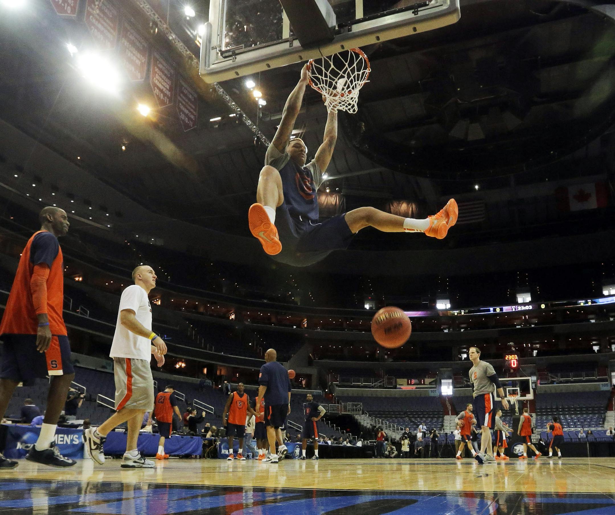 Syracuse forward DaJuan Coleman (32) dunks during practice for a regional semifinal game in the NCAA college basketball tournament, Wednesday, March 27, 2013, in Washington. Syracuse plays Indiana on Thursday. (AP Photo/Pablo Martinez Monsivais) ORG XMIT: VZN206
