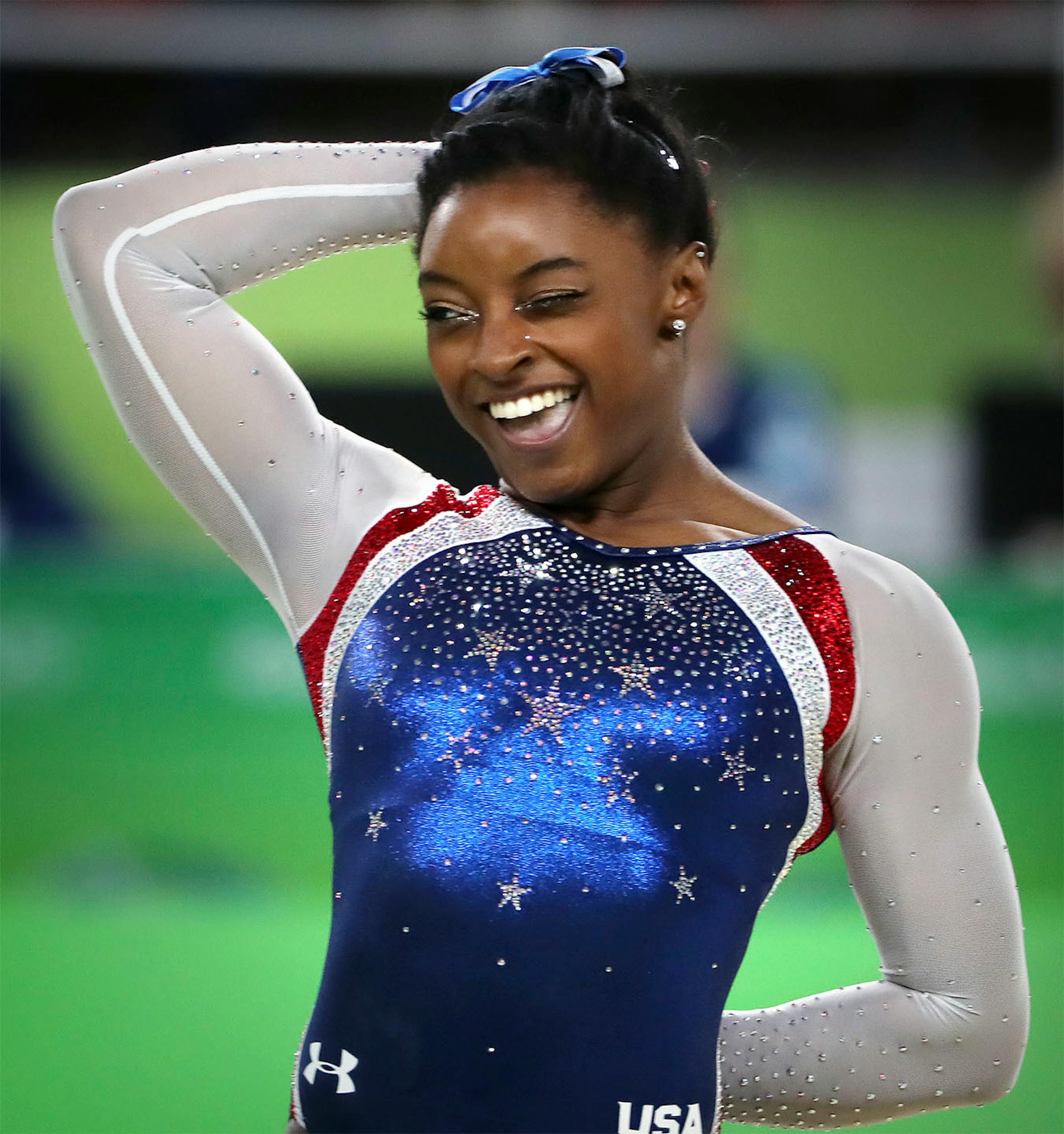 USA's Simone Biles won the all around title in women's gymnastics and her teammate Alexandra Raisman took home the silver. Here, Biles winks during her floor exercise and gives a big smile.