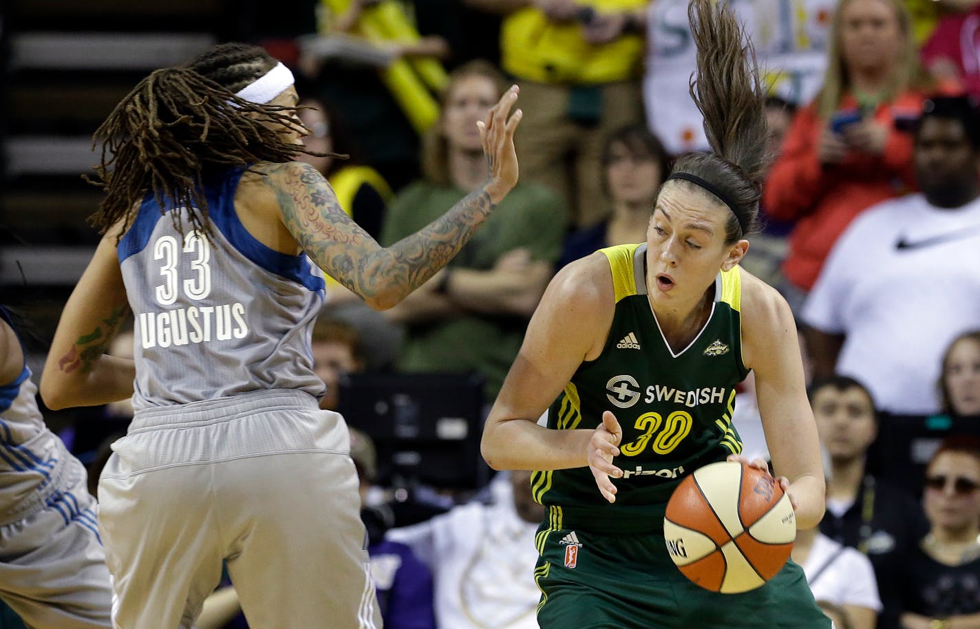 Seattle Storm's Breanna Stewart (30) drives as Minnesota Lynx's Seimone Augustus defends in the second half of a WNBA basketball game Sunday, May 22, 2016, in Seattle. The Lynx won 78-71. (AP Photo/Elaine Thompson)