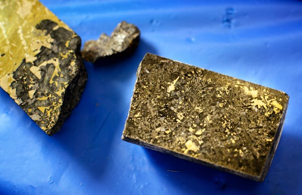 Flecks of ore containing copper, nickel, cobalt, palladium, platinum and gold seen in core samples taken from around PolyMet property. PolyMet Mine in