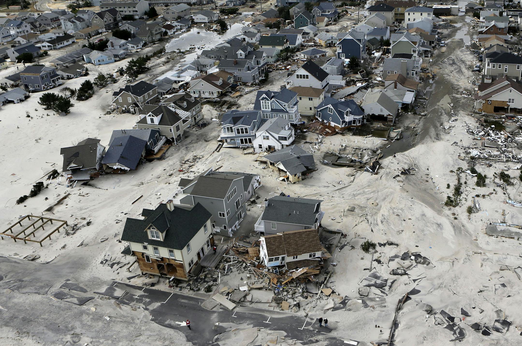 CORRECTS CITY TO ORTLEY BEACH, N.J. FILE - In an Oct. 31, 2012, file aerial photo, the destroyed and damaged homes are left in the wake of Superstorm Sandy in Ortley Beach, N.J. Researchers with the United States and British governments concluded Thursday Sept. 5, 2013, that climate change had made these events more likely: U.S. heat waves, Superstorm Sandy flooding, shrinking Arctic sea ice, drought in Europe's Iberian peninsula, and extreme rainfall in Australia and New Zealand. (AP Photo/Mike