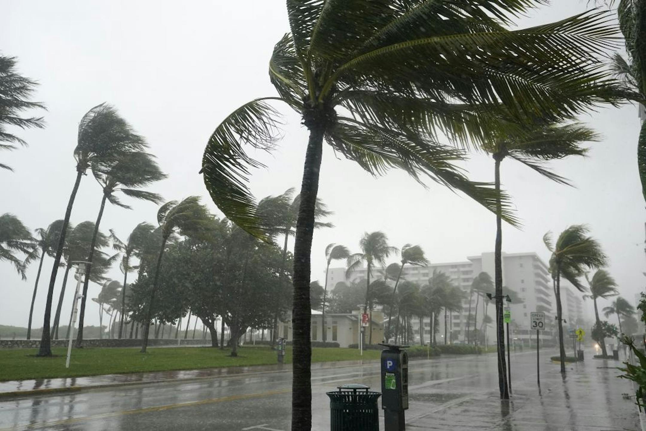 A normally bustling Ocean Drive is shown during a downpour, Sunday, Nov. 8, 2020, on Miami Beach, Florida's famed South Beach. A strengthening Tropical Storm Eta cut across Cuba on Sunday, and forecasters say it's likely to be a hurricane before hitting the Florida Keys Sunday night or Monday.