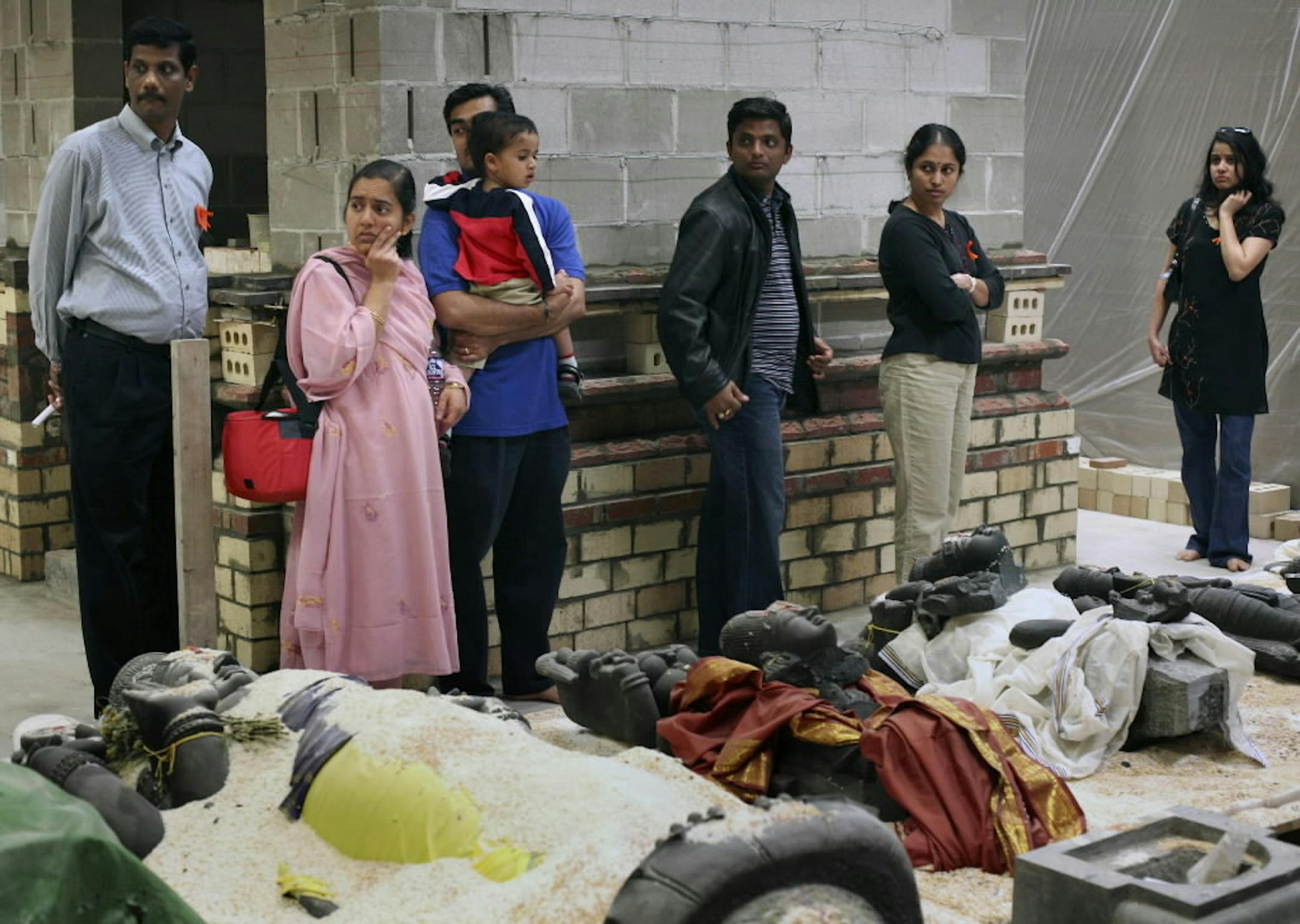 Apr. 13, 2006 After a community meeting attended by about 600 people, members of the new Hindu temple in Maple Grove looked at statues from India damaged by vandals. Photo Publication Date: April 19, 2006