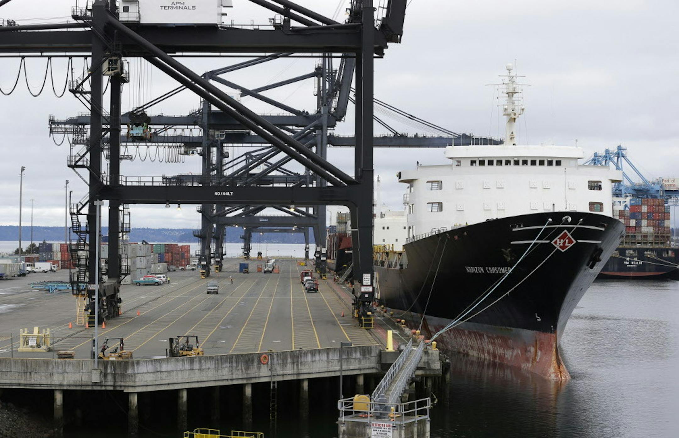 A ship operated by Horizon Lines, Inc. sits docked at the Port of Tacoma, Friday, Feb. 20, 2015, in Tacoma, Wash. With a Friday deadline looming, negotiators for the two sides in the contract dispute that has snarled international trade at U.S. West Coast seaports are laboring to reach a settlement as billions of dollars of cargo are sitting massive ocean-going ships anchored outside port facilities. (AP Photo/Ted S. Warren)
