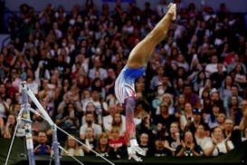 Simone Biles competes on the uneven bars on Day 2 of the U.S. women's gymnastics Olympic trials at Target Center on Sunday.