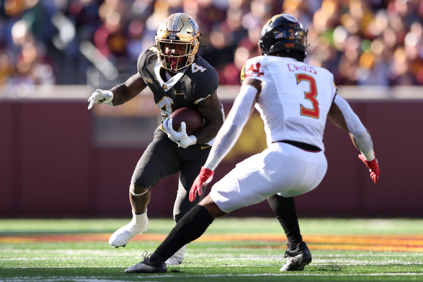 Minnesota running back Mar'Keise Irving (4) carries the ball against Maryland defensive back Nick Cross (3) during an NCAA college football game Saturday, Oct. 23, 2021, in Minneapolis. (AP Photo/Stacy Bengs)