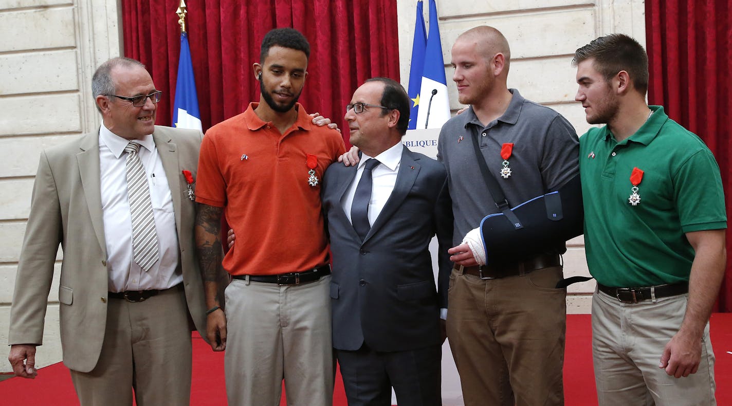 From the left, British businessman Chris Norman, Anthony Sadler, a senior at Sacramento University in California, French President Francois Hollande, U.S. Airman Spencer Stone, and Alek Skarlatos a U.S. National Guardsman from Roseburg, Oregon, pose at the Elysee Palace, Monday Aug.24, 2015 in Paris, France. Hollande pinned the Legion of Honor medal on U.S. Airman Spencer Stone, National Guardsman Alek Skarlatos, and their years-long friend Anthony Sadler, who subdued the gunman as he moved thro