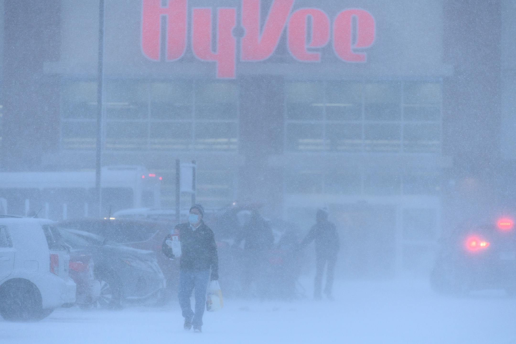 A person brought groceries out to their car outside HyVee during Wednesday's snow storm.