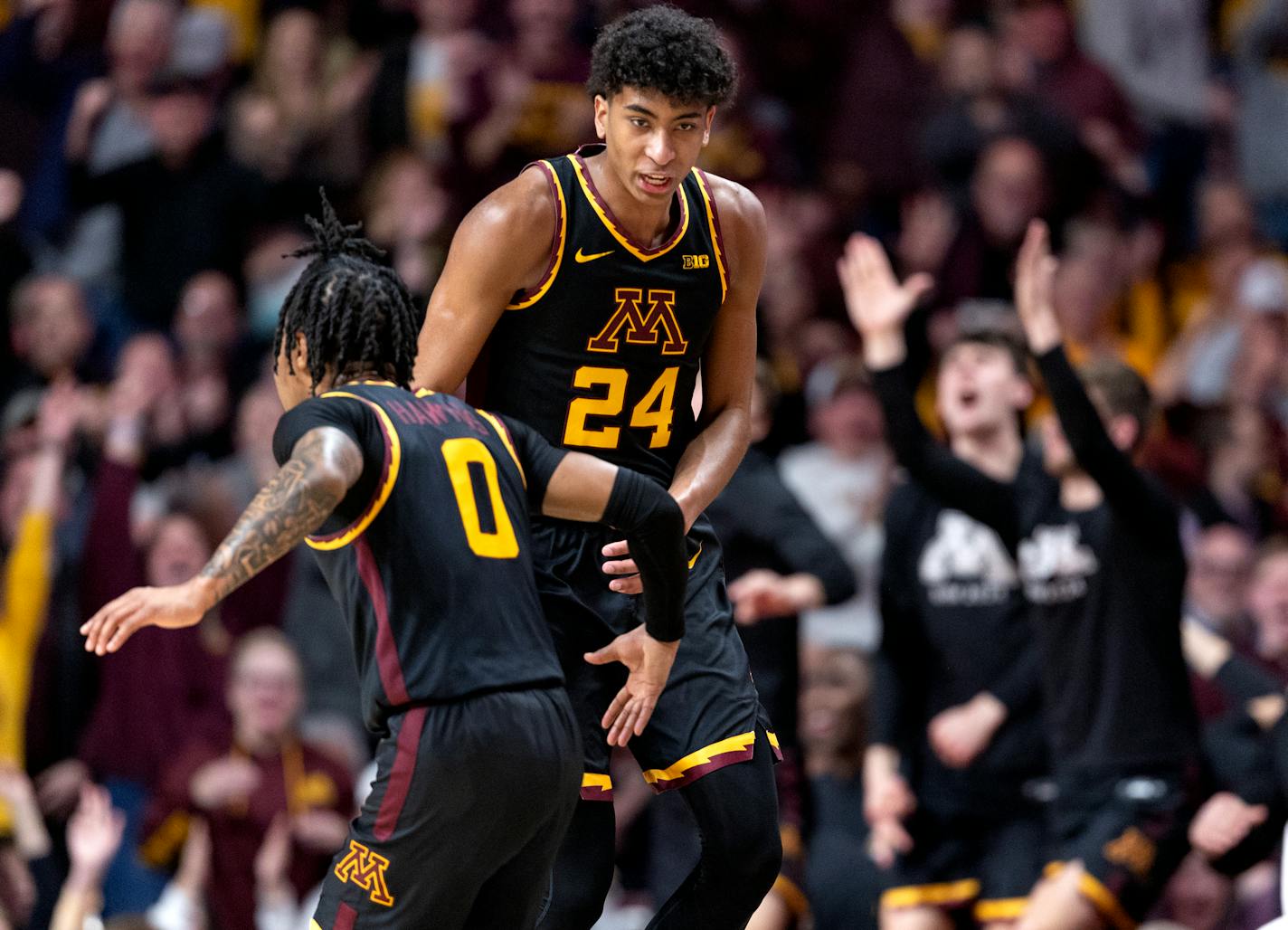 Cam Christie (24) of Minnesota celebrates a three pointer in the second half.