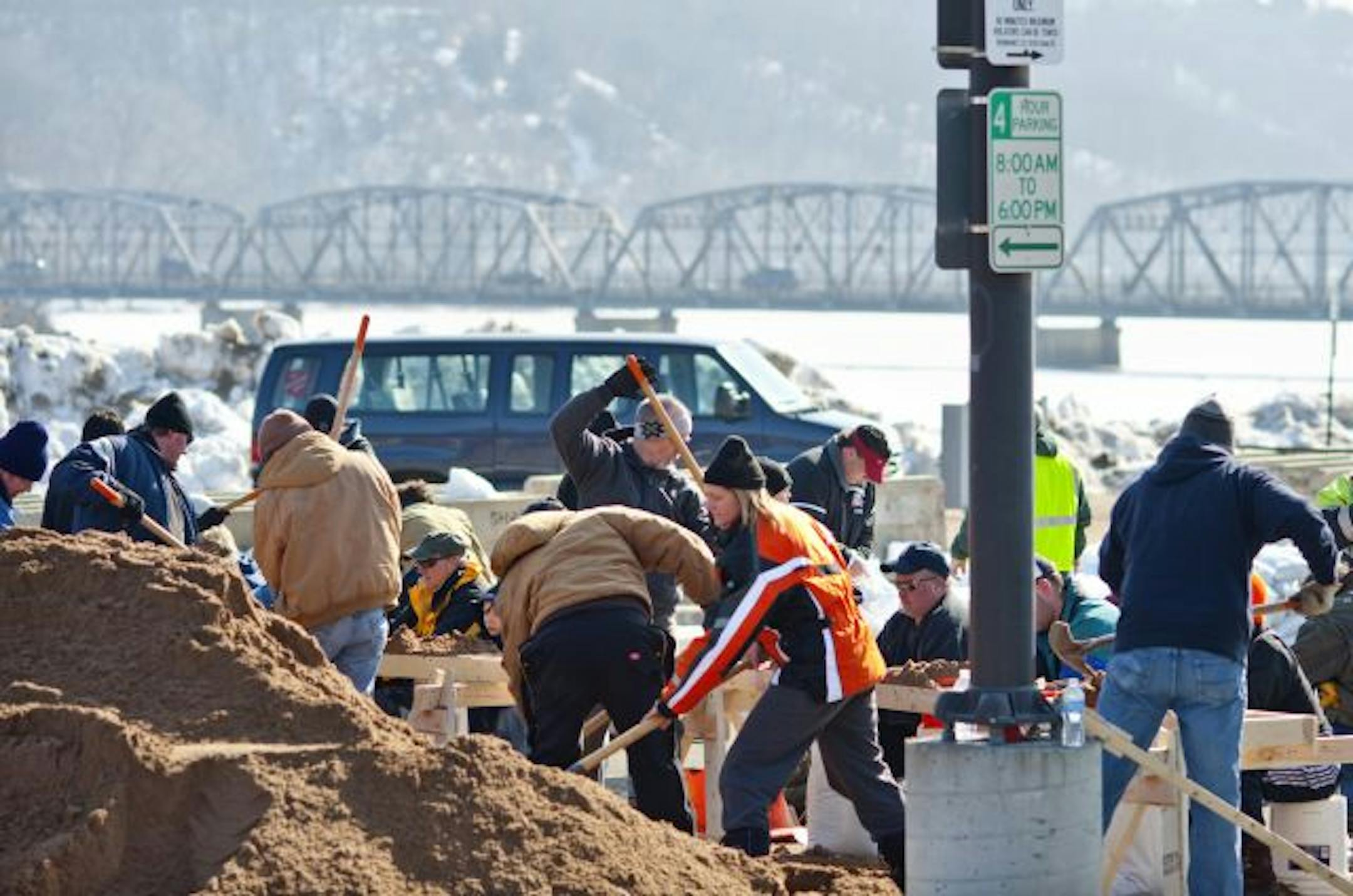Piles of sand and piles of bags are quickly being turned into the raw material for dikes in Stillwater. Such work is beginning in earnest in river towns throughout the area.