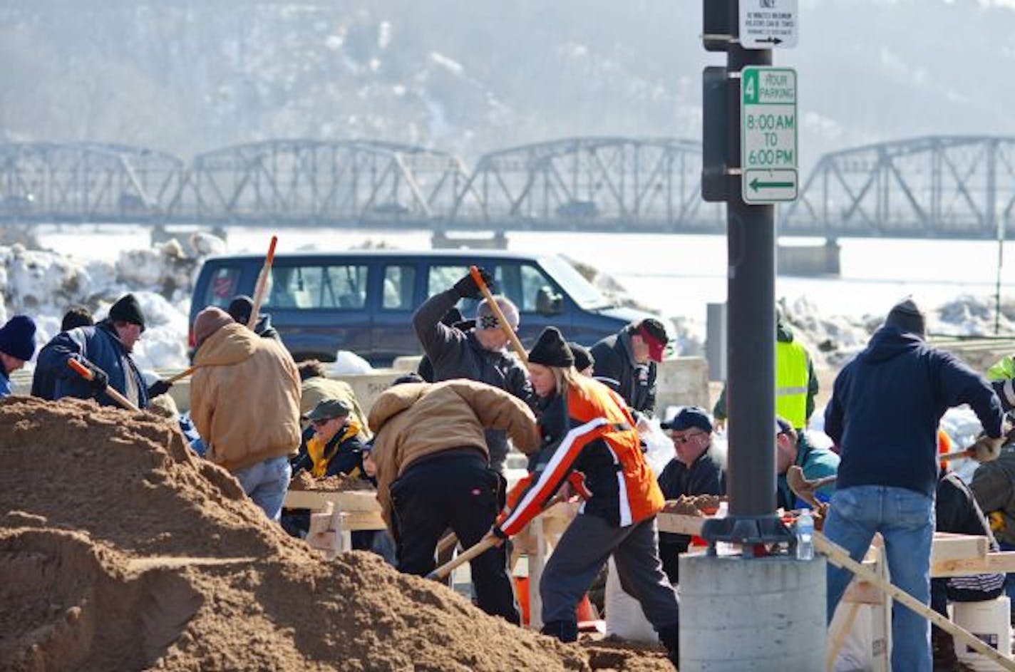 Piles of sand and piles of bags are quickly being turned into the raw material for dikes in Stillwater. Such work is beginning in earnest in river towns throughout the area.