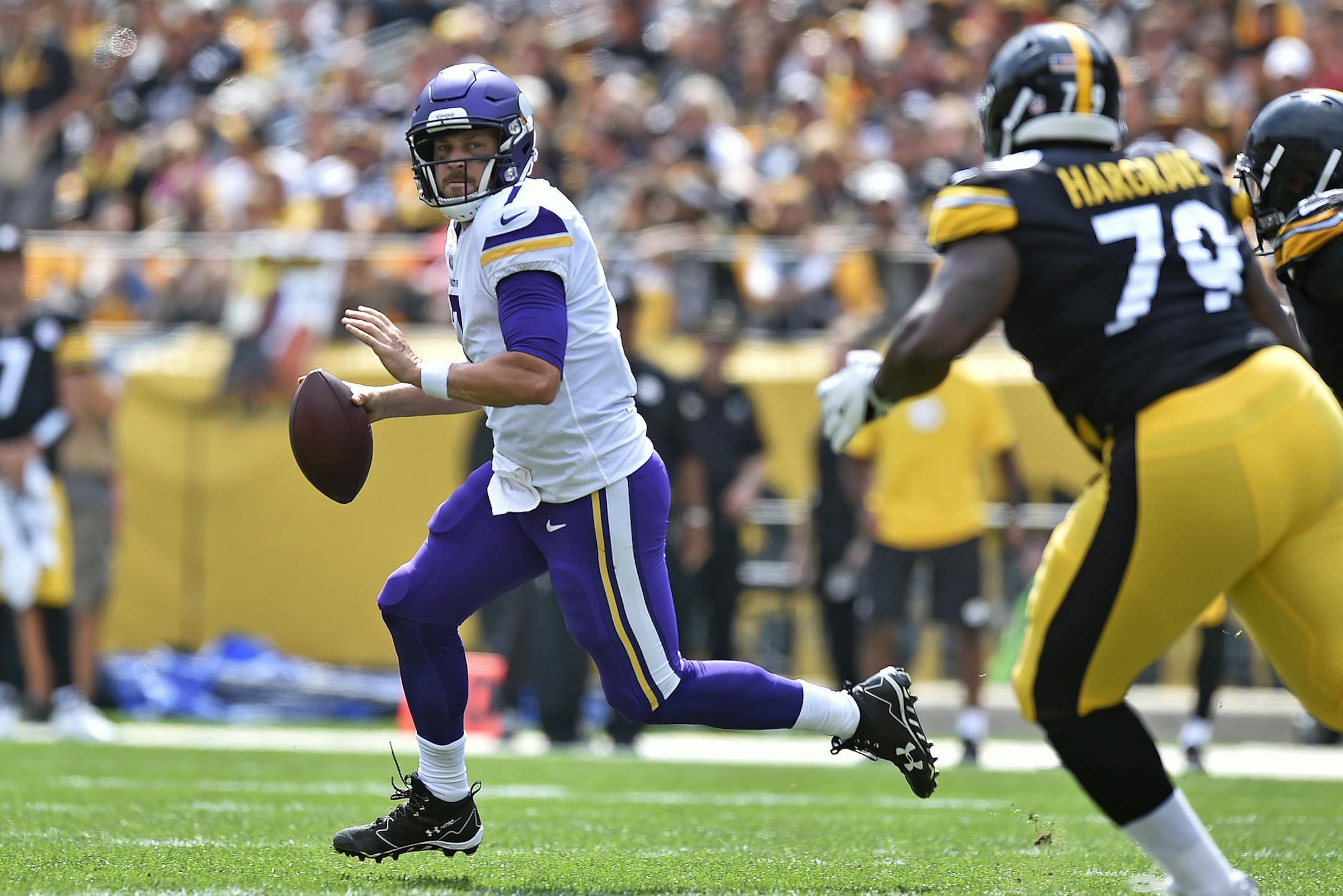 Minnesota Vikings quarterback Case Keenum (7) rolls out during the first half of an NFL football game against the Pittsburgh Steelers in Pittsburgh, Sunday, Sept. 17, 2017. (AP Photo/Don Wright)