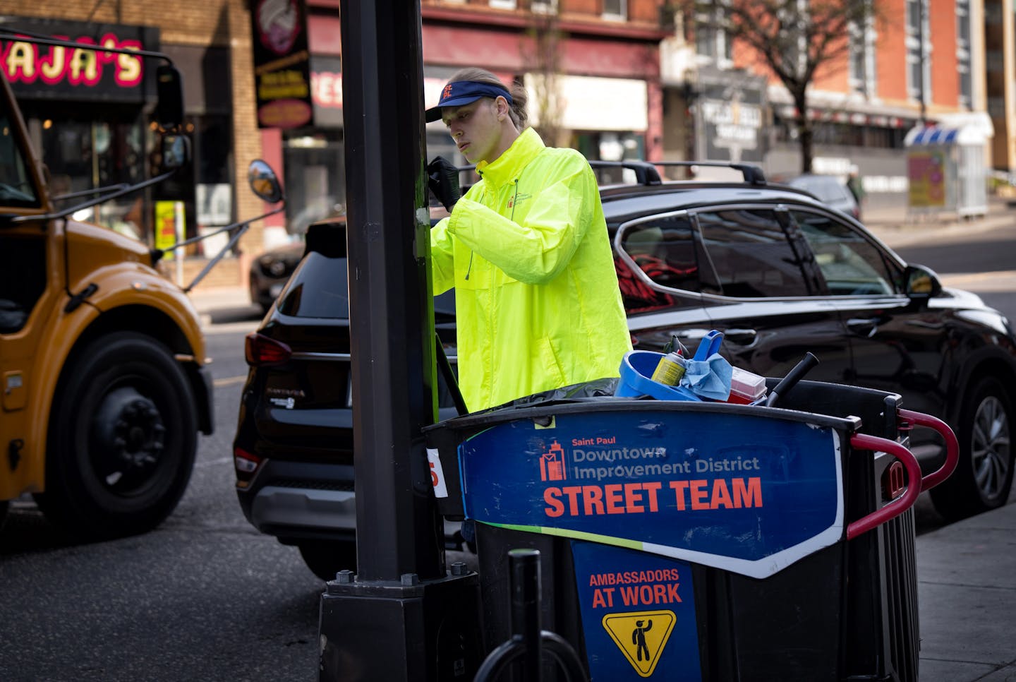 Joseph Bier scraped stickers and graffiti from lampposts and bicycle racks along St. Paul’s W. 7th Street on Wednesday, May 10, 2023. Businesses alo