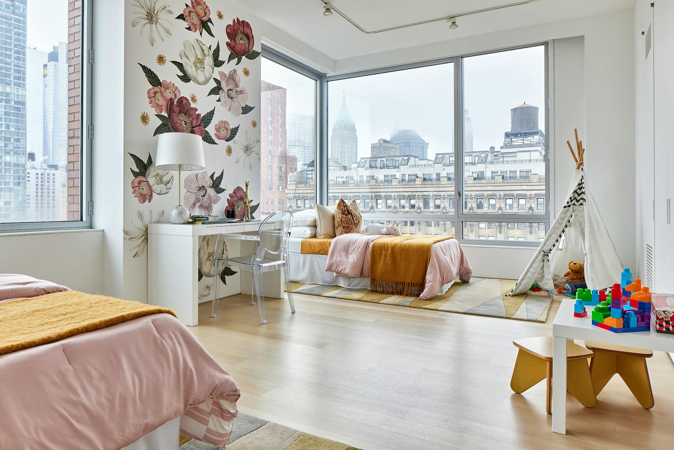 Large flower wall decals cover one wall in a children's bedroom.