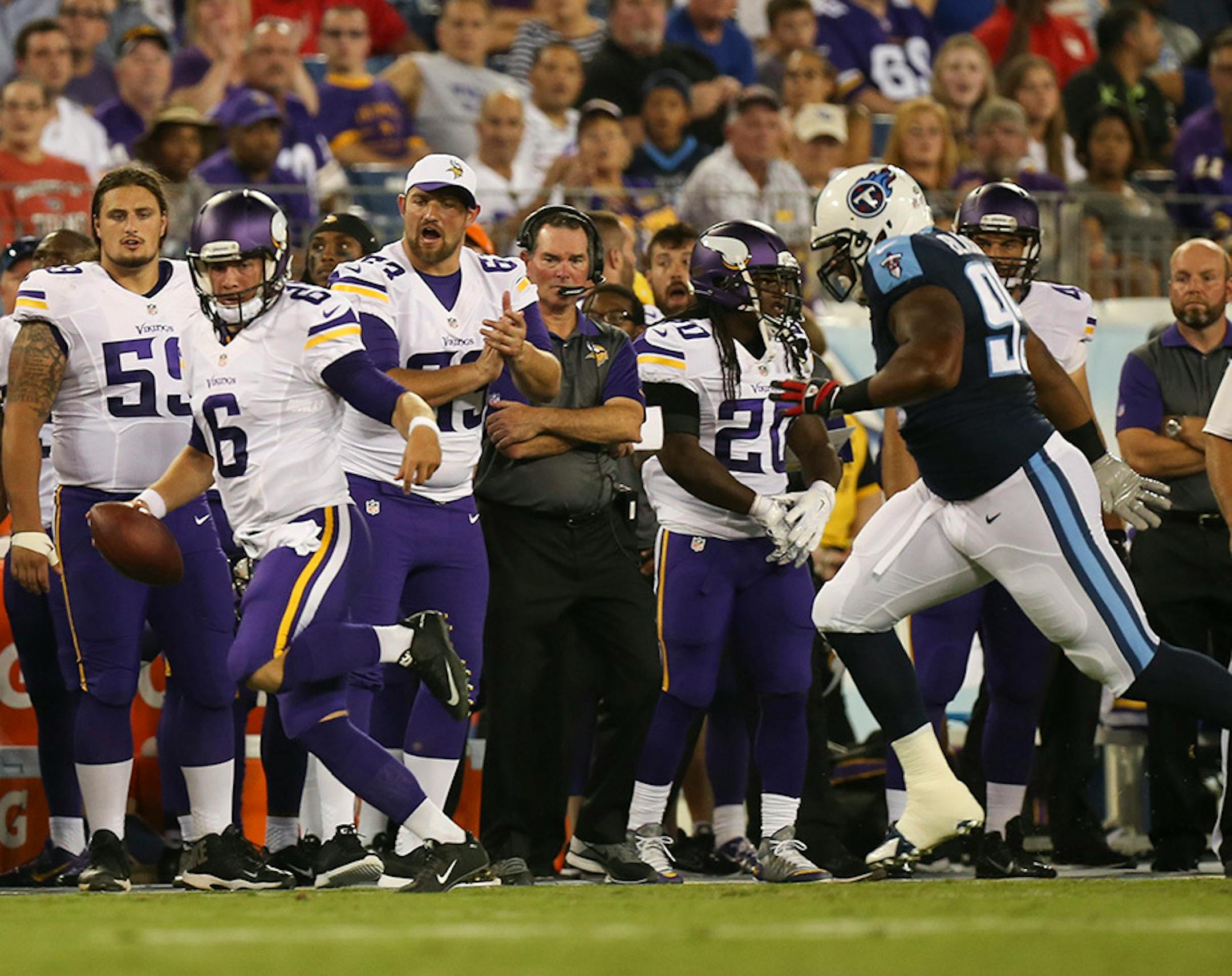 Vikings starting quarterback Taylor Heinicke scrambled for an 18 yard gain before being pushed out of bounds by Tennessee Titans defensive tackle Angelo Blackson (95) in the first quarter Thursday night.