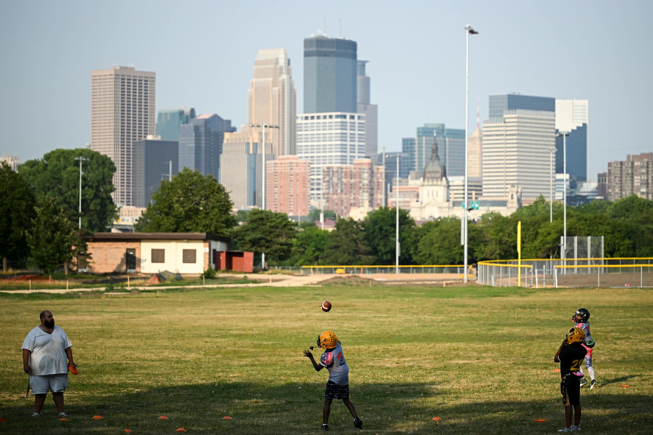 Coach Adel Morey, left, watches as players practice at Bryn Mawr Meadows Park.