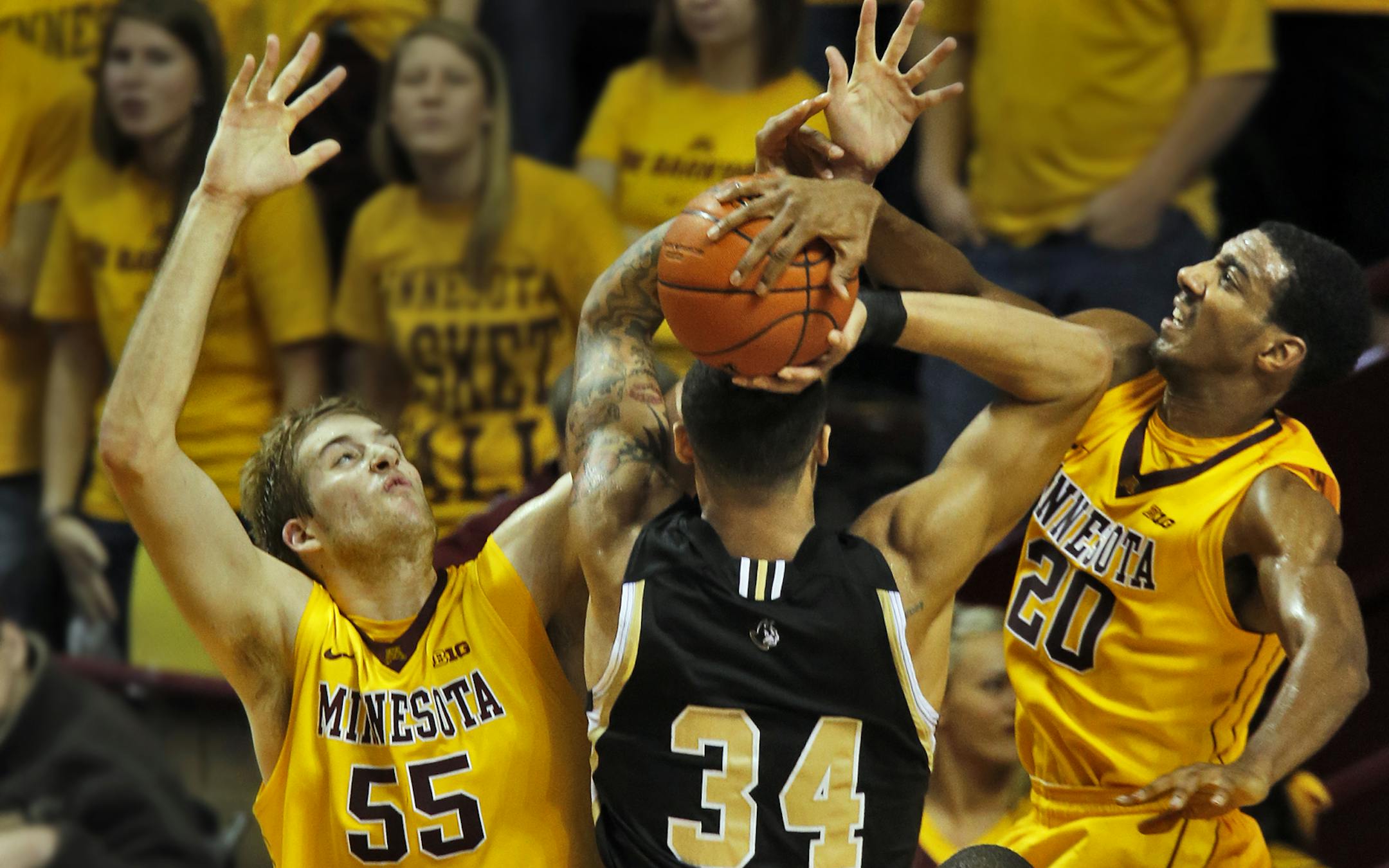 UM Gophers vs. Wofford basketball. Minnesota defenders Elliott Eliason (55) and Austin Hollins blocked Woffard's Lee Skinner's field goal attempt. (MARLIN LEVISON/STARTRIBUNE(mlevison@startribune.com)