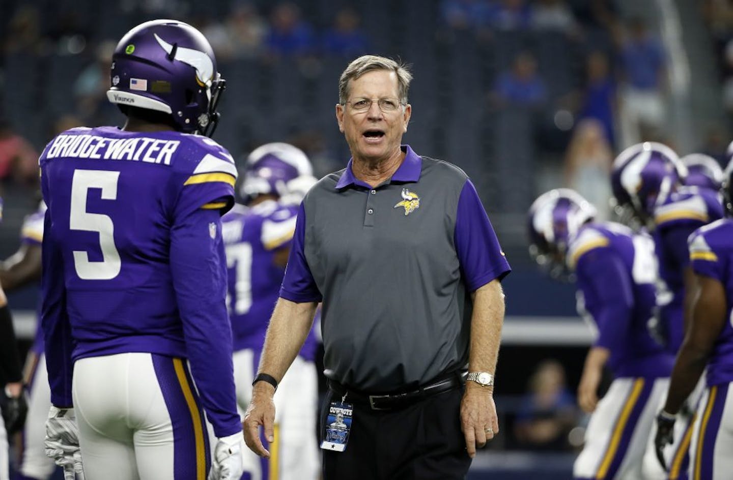 Minnesota Vikings' Teddy Bridgewater (5) talks with offensive coordinator Norv Turner during warm ups before a preseason NFL football game against the Dallas Cowboys Saturday, Aug. 29, 2015, in Arlington, Texas.