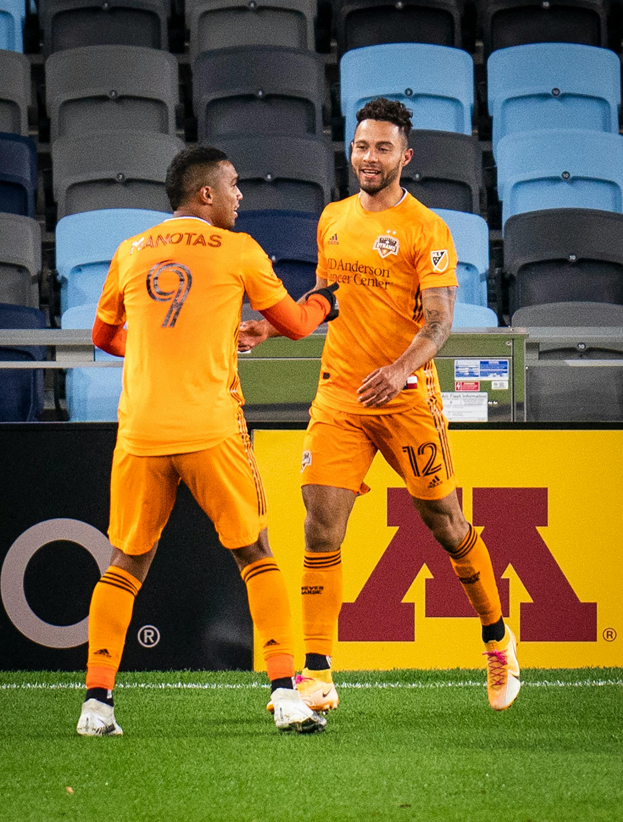 Houston Dynamo midfielder Niko Hansen (12), right, celebrated his goal that tied the game 2-2 with Houston Dynamo forward Mauro Manotas (9) during the second half.