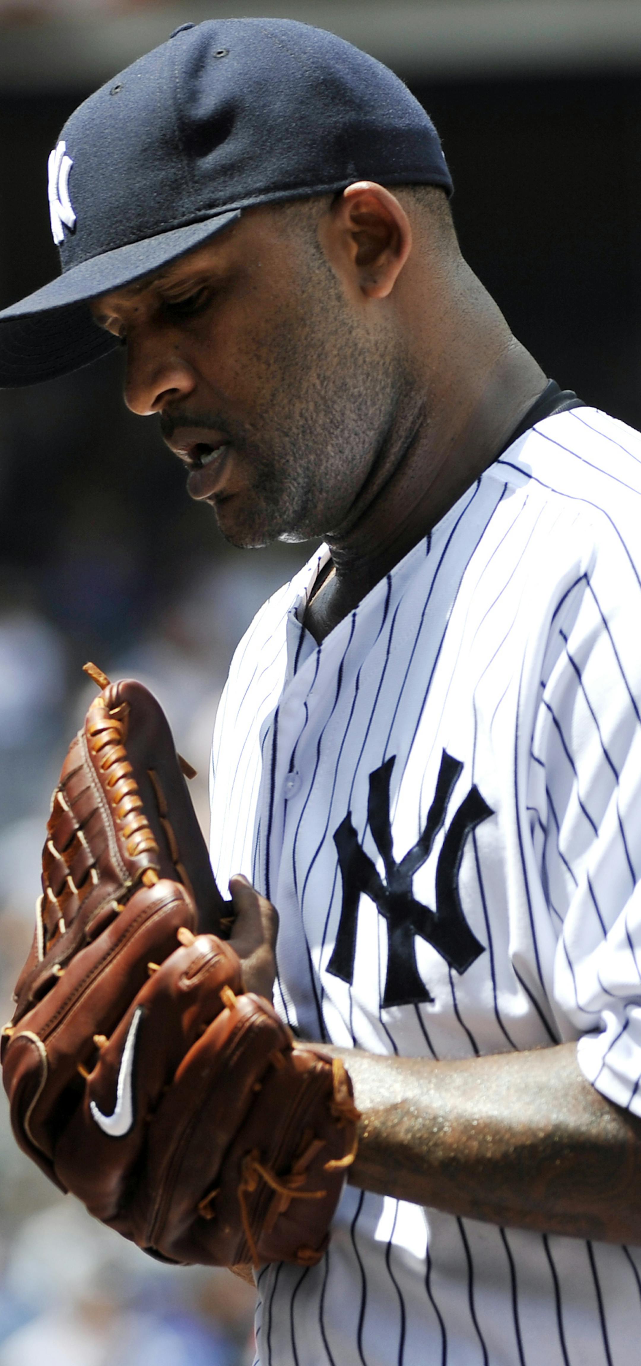 New York Yankees starting pitcher CC Sabathia walks off the field at the top of the third inning after giving up a three-run home run to Minnesota Twins' Aaron Hicks in a baseball game at Yankee Stadium on Sunday, July 14, 2013 in New York. The Twins won 10-4. (AP Photo/Kathy Kmonicek)