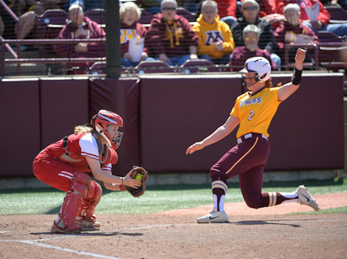 Minnesota's Dani Wagner (2) slid safely to home as Wisconsin catcher Melanie Cross (12) was unable to get the tag in the bottom of the fourth inning.    ] AARON LAVINSKY • aaron.lavinsky@startribune.com