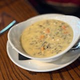A bowl of creamy chicken wild rice soup at Grackle.